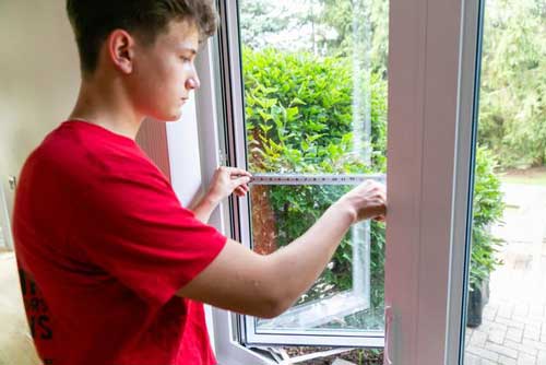 Young Man Fixing Glass — Palatine, IL — Sliding Door & Window