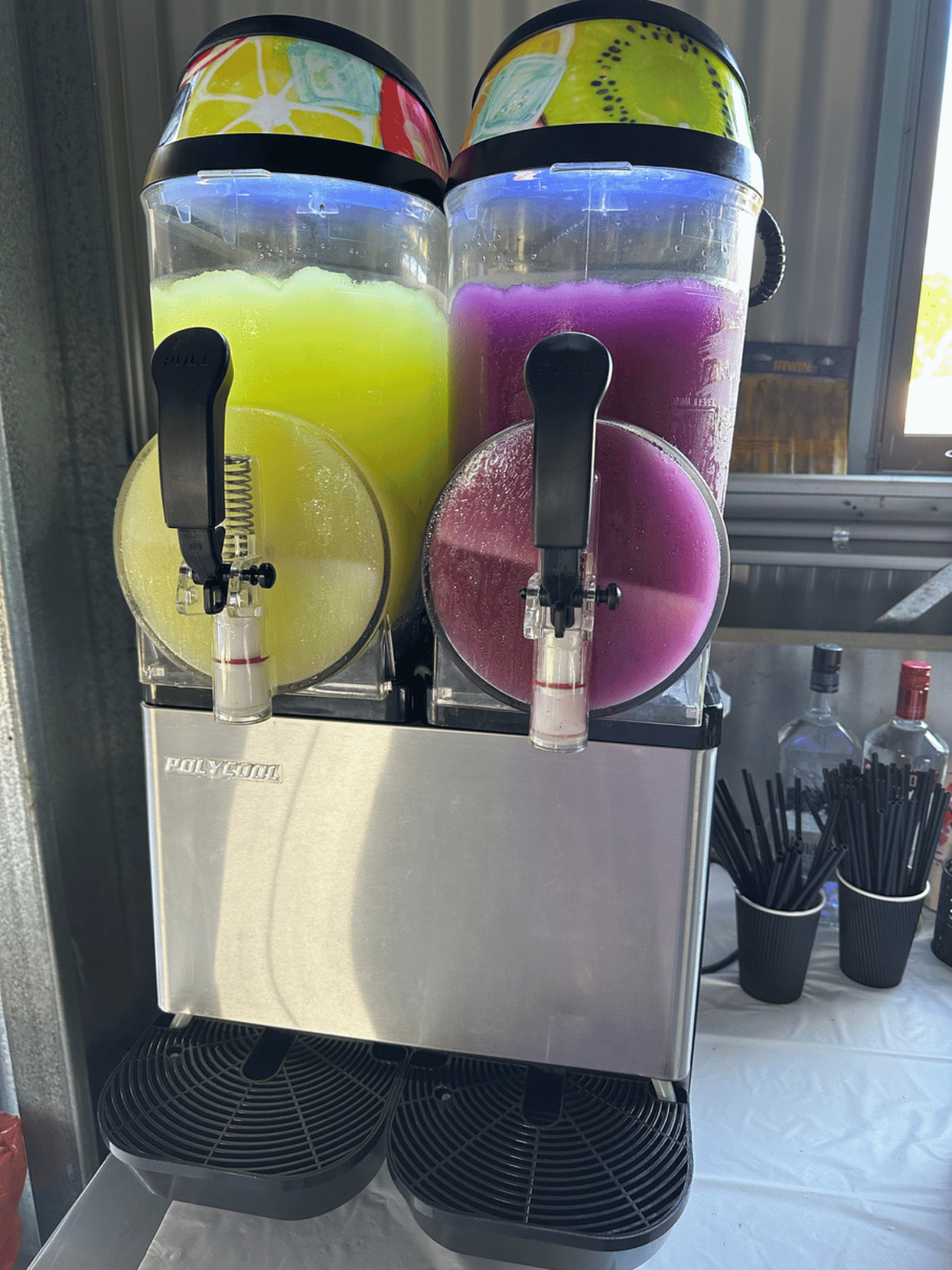 A slushie machine that is filled with two different coloured liquids.
