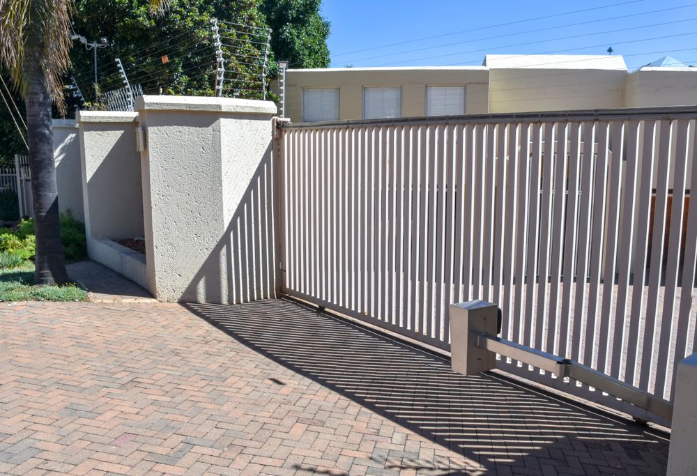 A Sliding Gate is Open to a Driveway in Front of a Building — WeFence in Lisarow, NSW