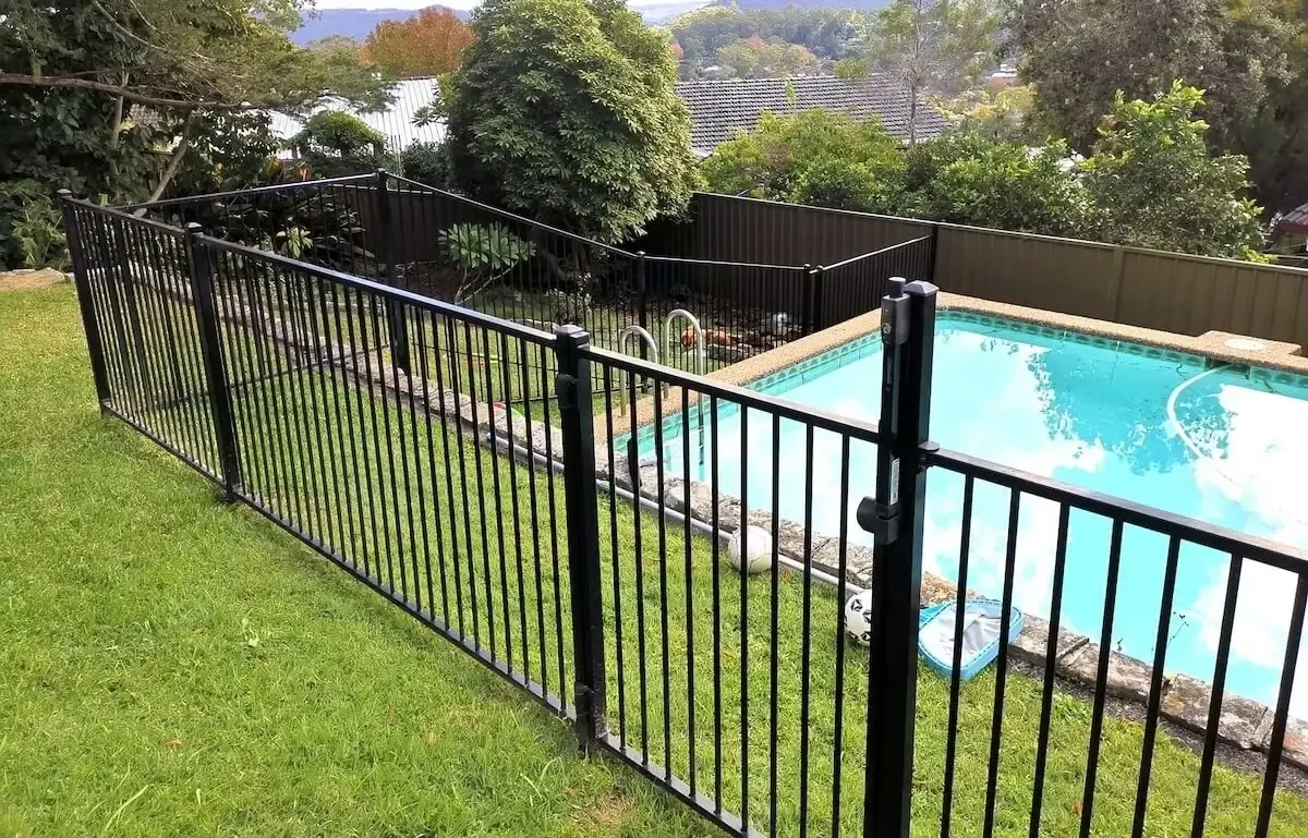 A Black Metal Fence Surrounds a Wooden Deck — WeFence in Lisarow, NSW