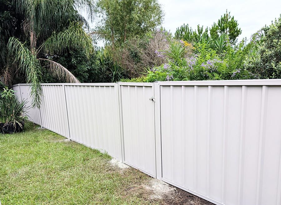 A White Fence With a Gate in the Backyard of a House — WeFence in Lisarow, NSW