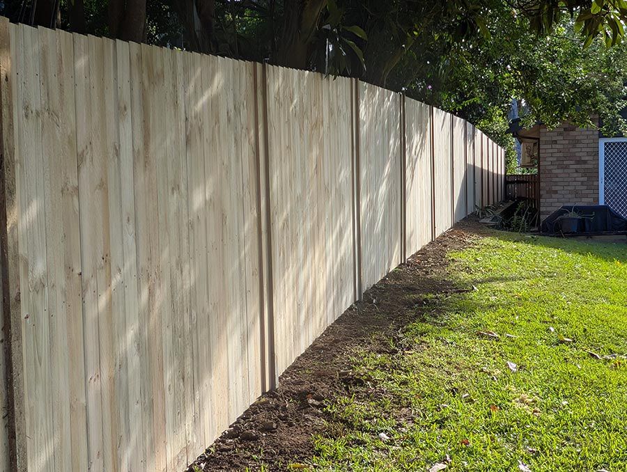 A Wooden Fence is Sitting in the Middle of a Lush Green Field — WeFence in Lisarow, NSW