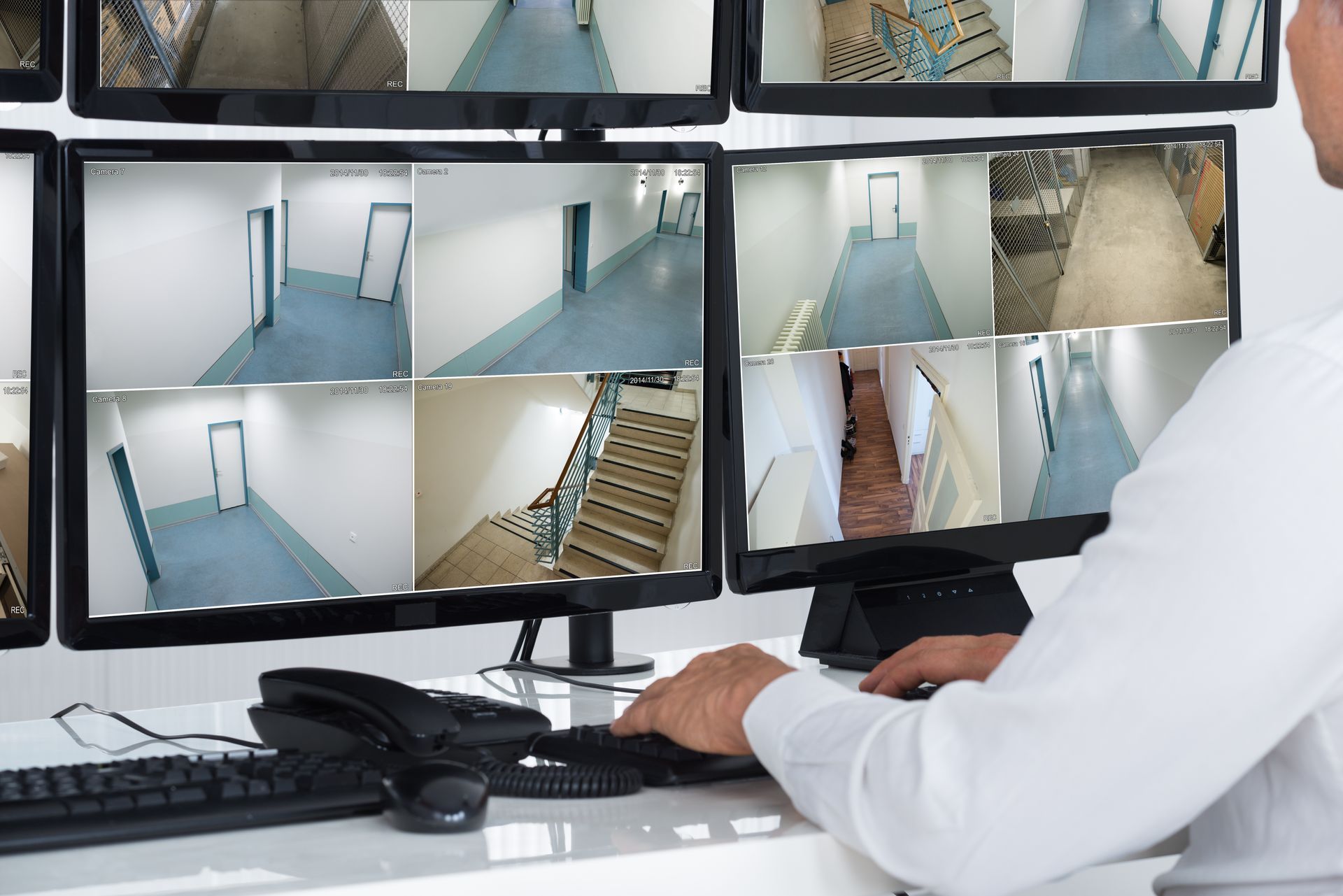 Security system operator monitoring CCTV footage as part of professional security services.