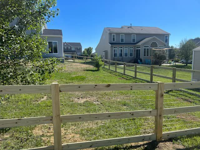 A Wooden Fence In Front Of A House — Chesterton, IN — Claycor Construction
