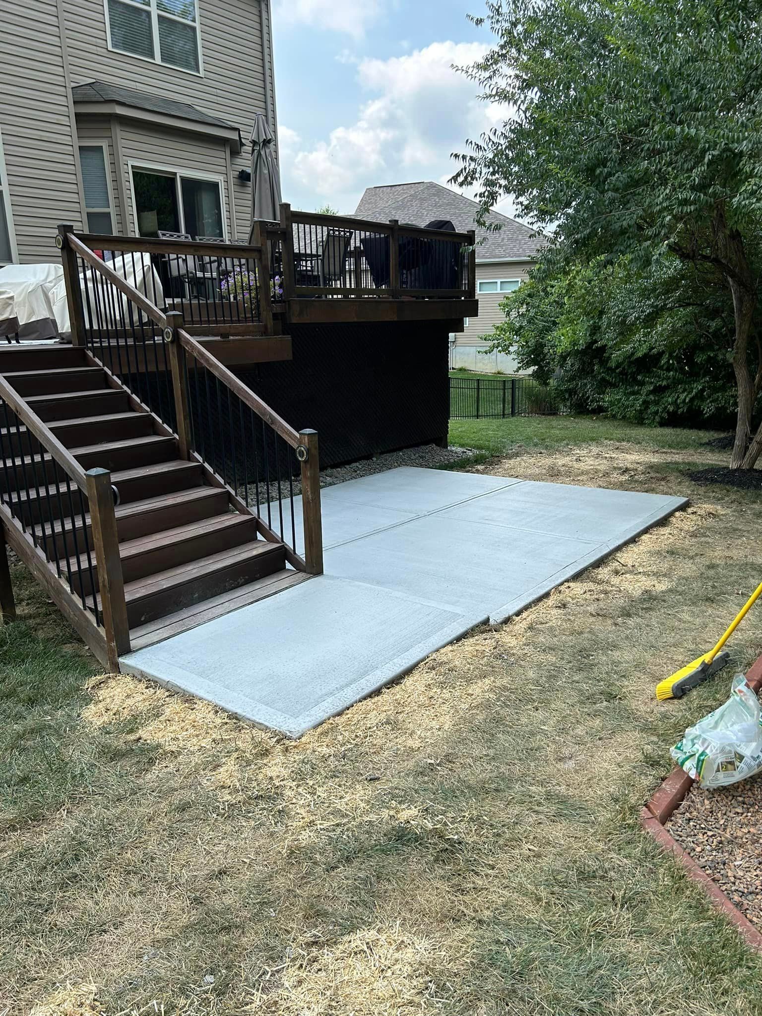 A Backyard with Deck and Stairs and A Concrete Walkway — Chesterton, IN — Claycor Construction