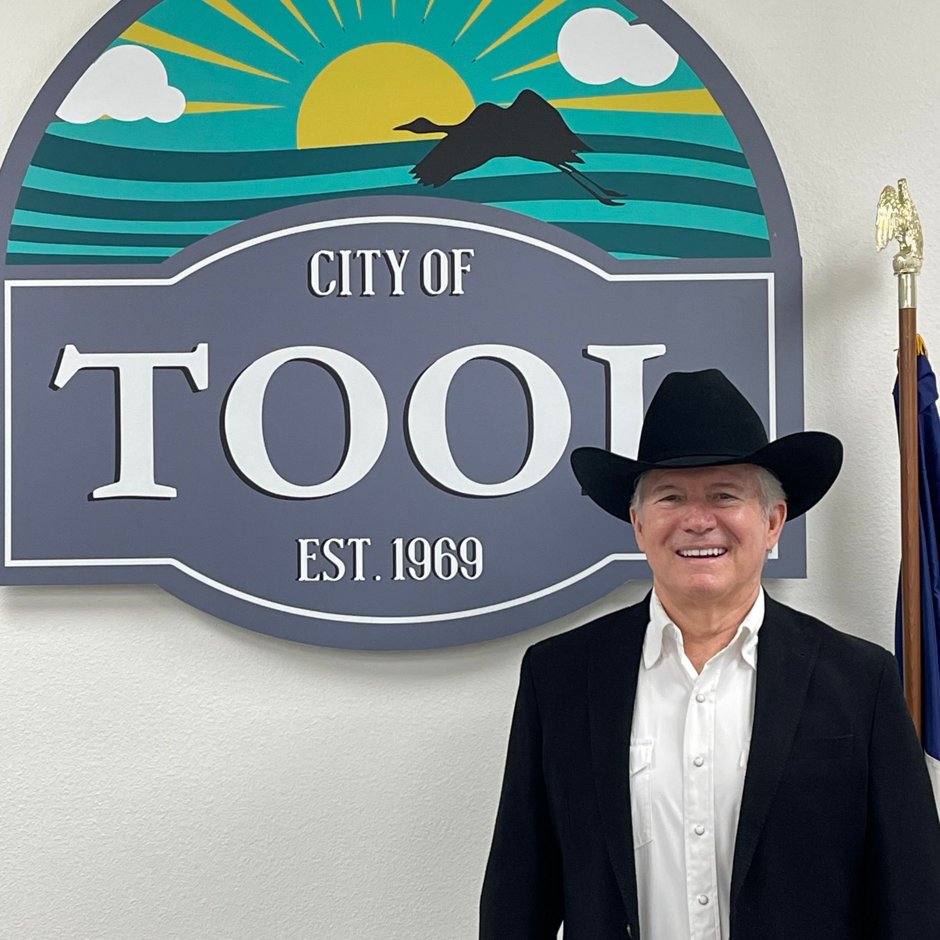 Man in cowboy hat stands in front of a