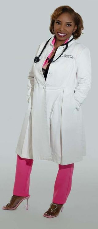 A woman wearing a white coat and pink pants with a stethoscope around her neck.