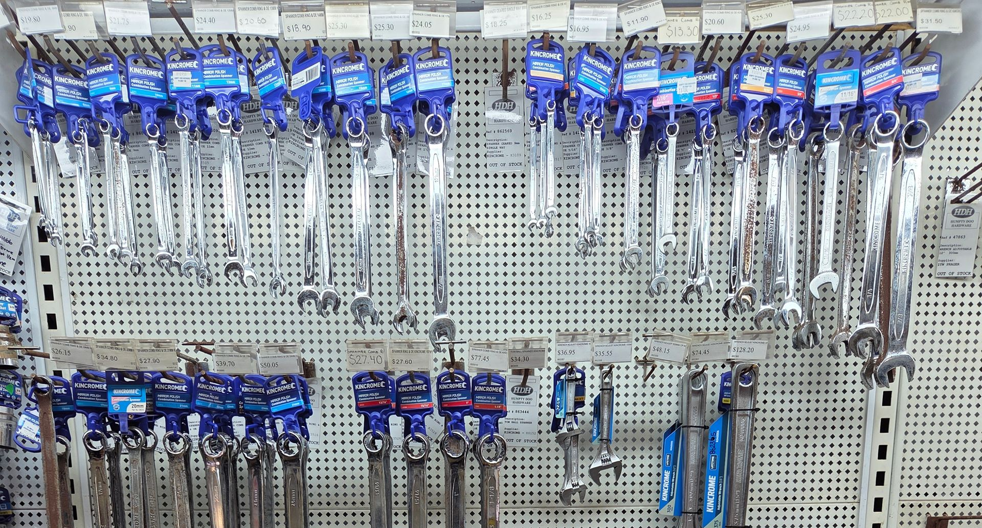 Assorted wrenches and hand tools hanging on a pegboard display in a hardware store. — Humpty Doo Hardware in Humpty Doo, NT