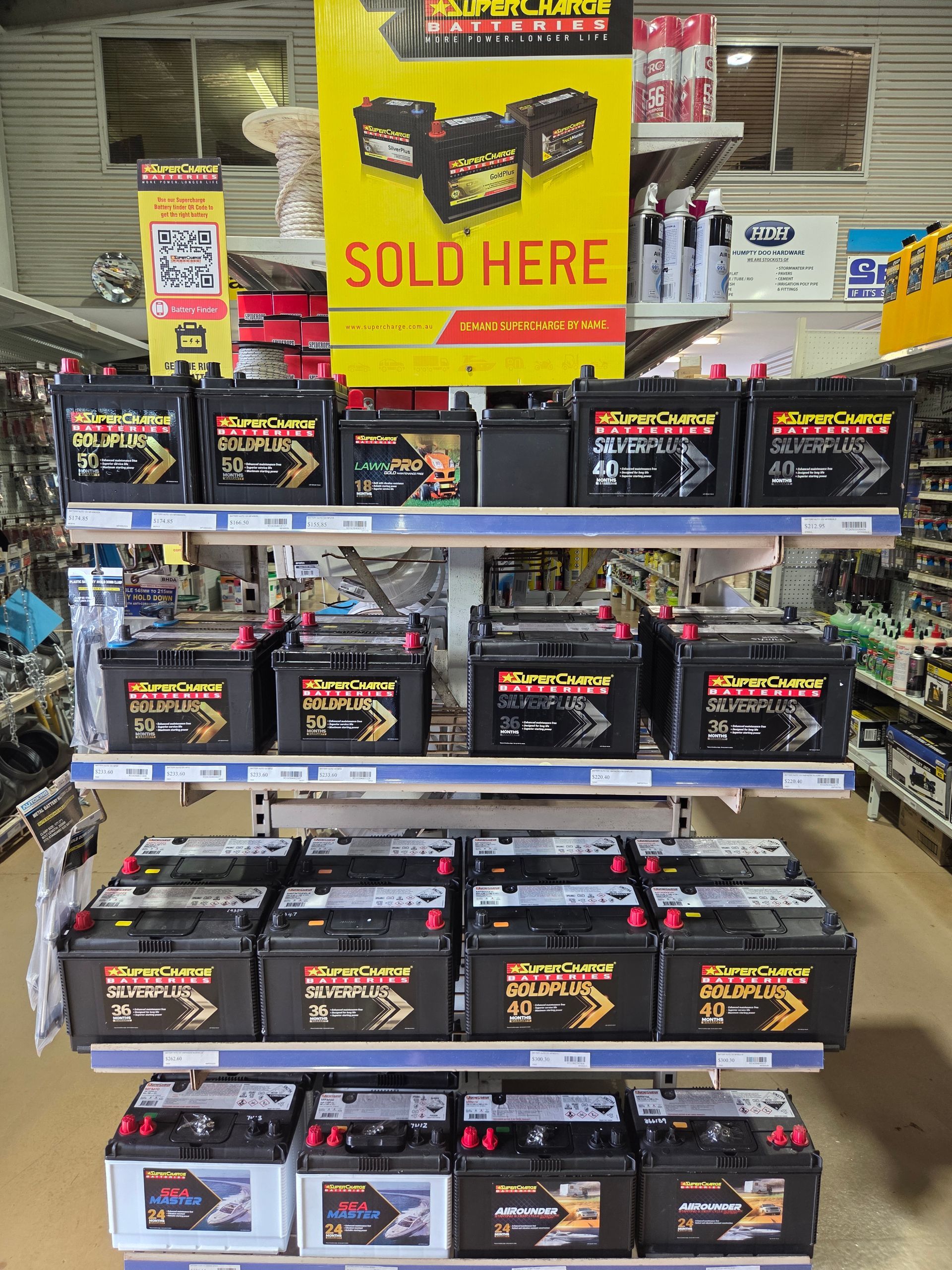 Retail Store Shelf Display Showcasing Rows of Various Automotive Batteries — Humpty Doo Hardware in Humpty Doo, NT