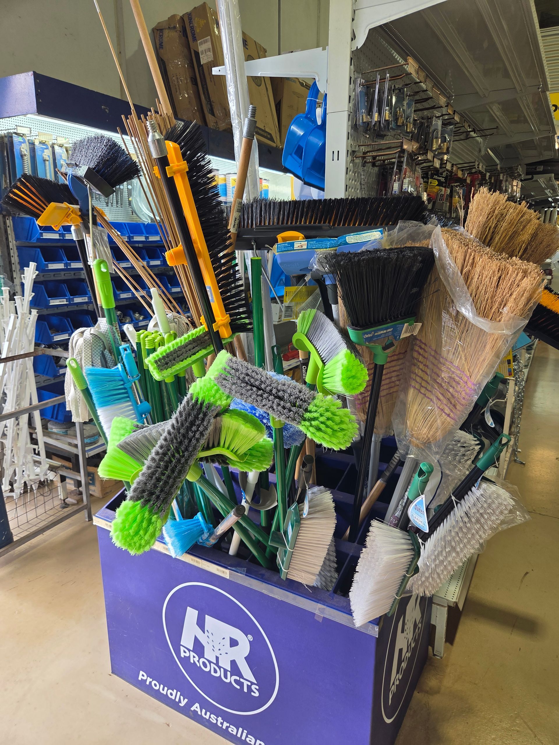 A Store Display Bin Filled With Various Cleaning Brushes — Humpty Doo Hardware in Humpty Doo, NT
