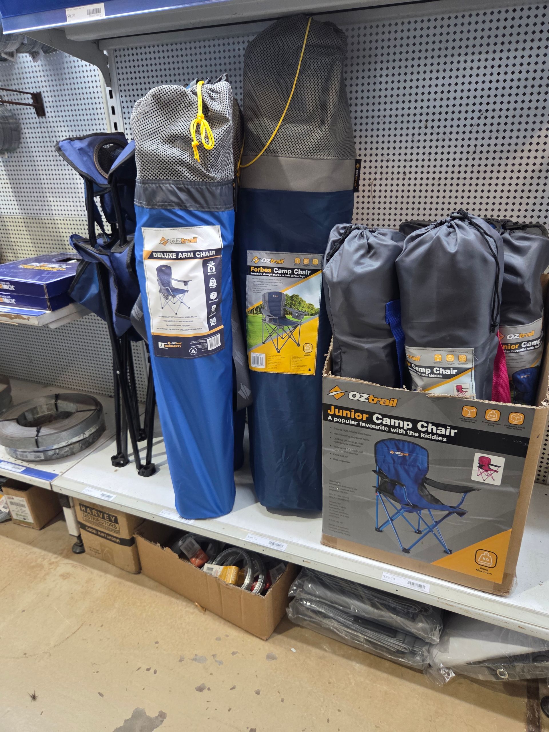 Camping Chairs in Blue and Gray Storage Bags Sitting on a Retail Shelf — Humpty Doo Hardware in Humpty Doo, NT
