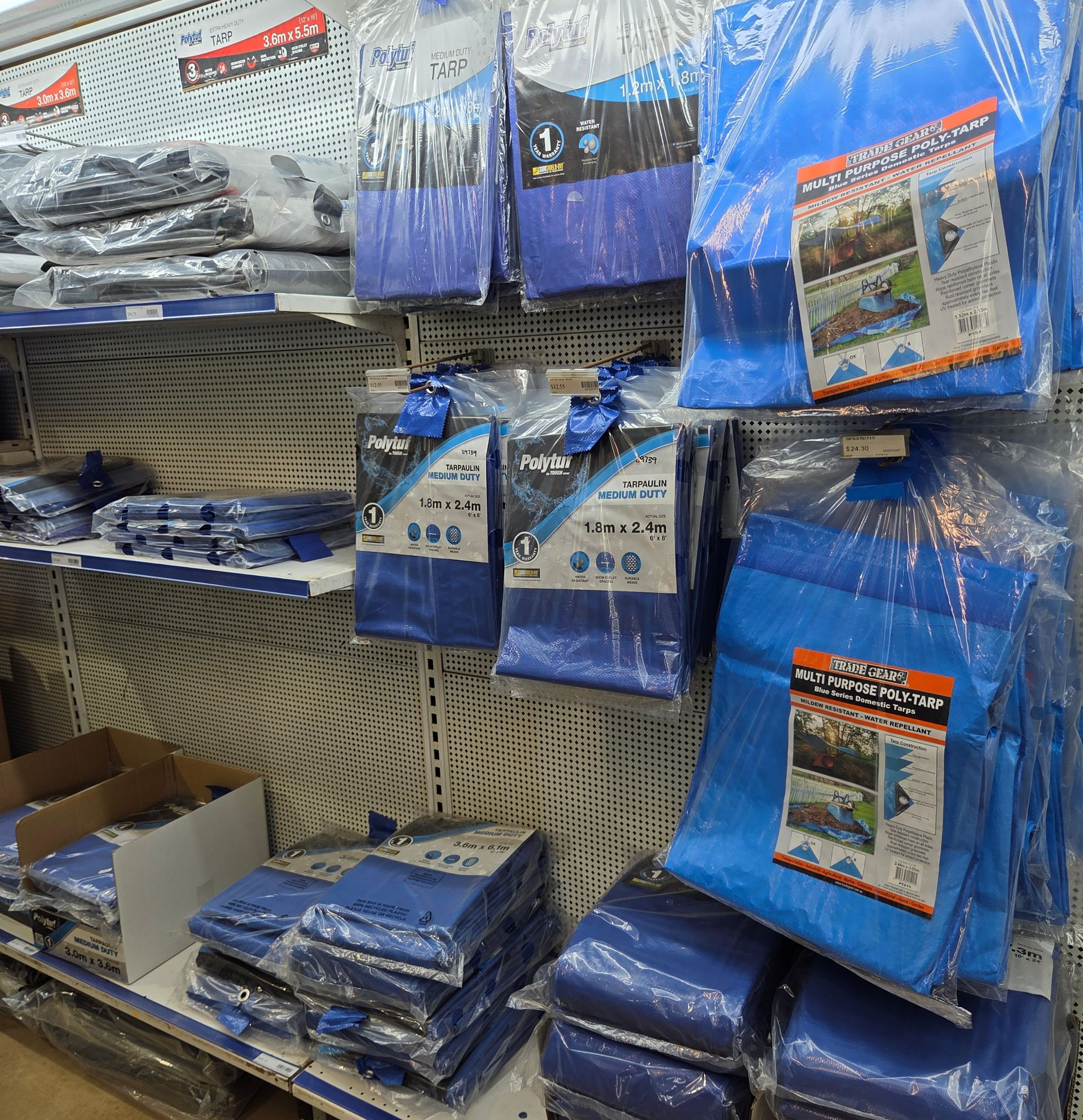 Store Shelves Stocked With Multiple Packages of Blue Tarps in Clear Plastic Packaging — Humpty Doo Hardware in Humpty Doo, NT