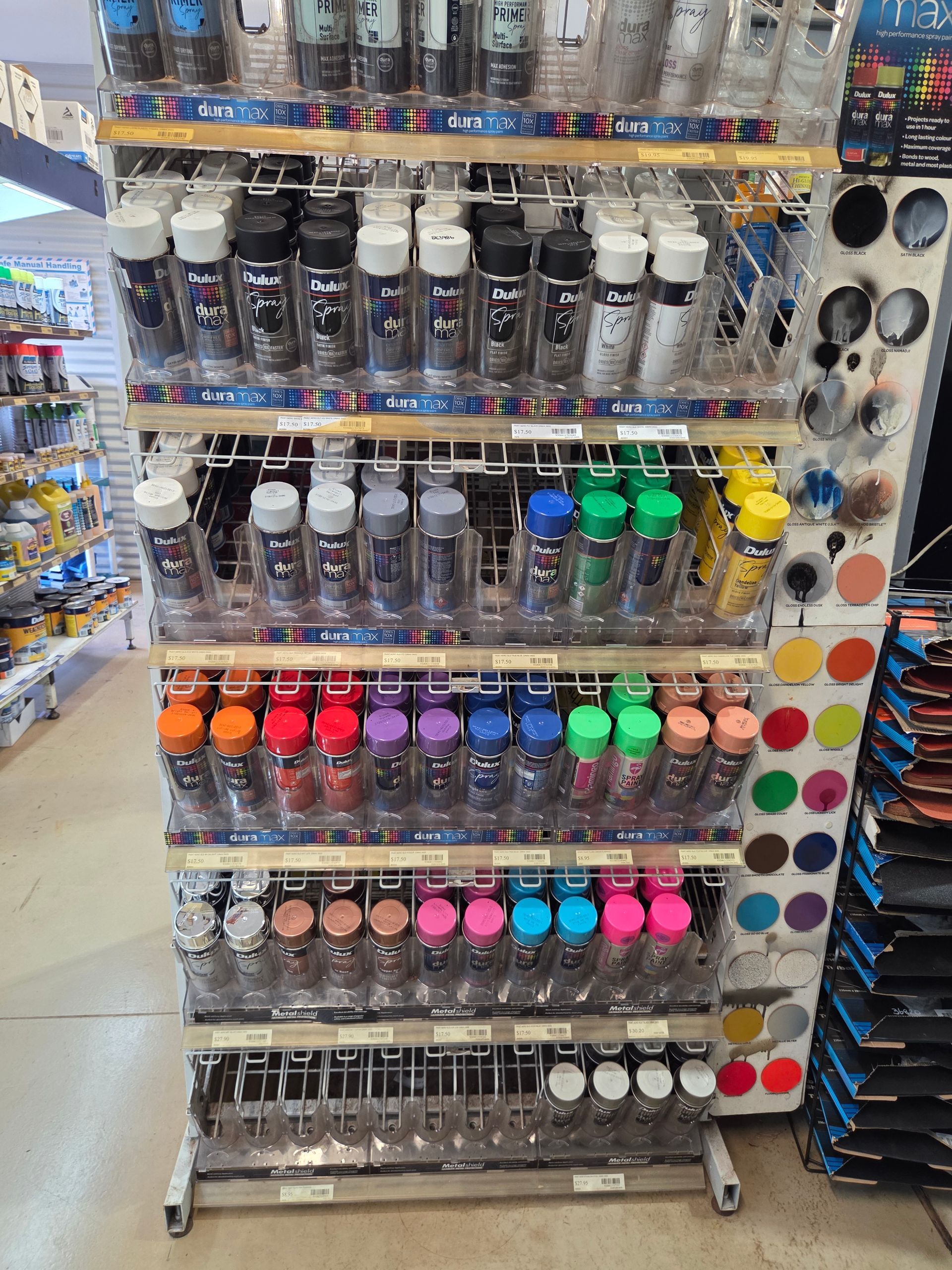 A Retail Store Display Rack Filled With Rows of Multi-coloured Spray Paint Cans — Humpty Doo Hardware in Humpty Doo, NT