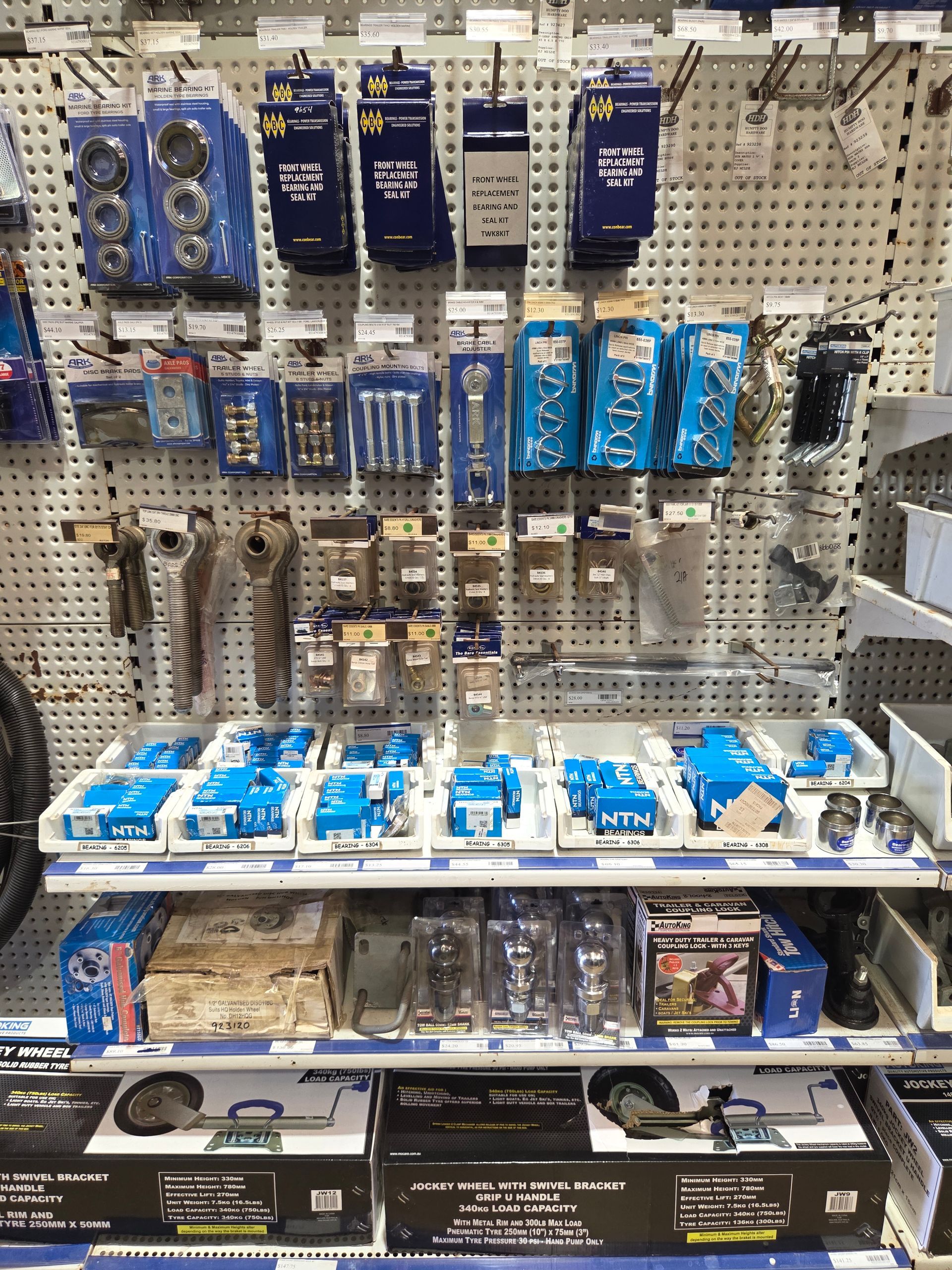 Store display of blue and black automotive accessories hanging on a pegboard shelf. — Humpty Doo Hardware in Humpty Doo, NT