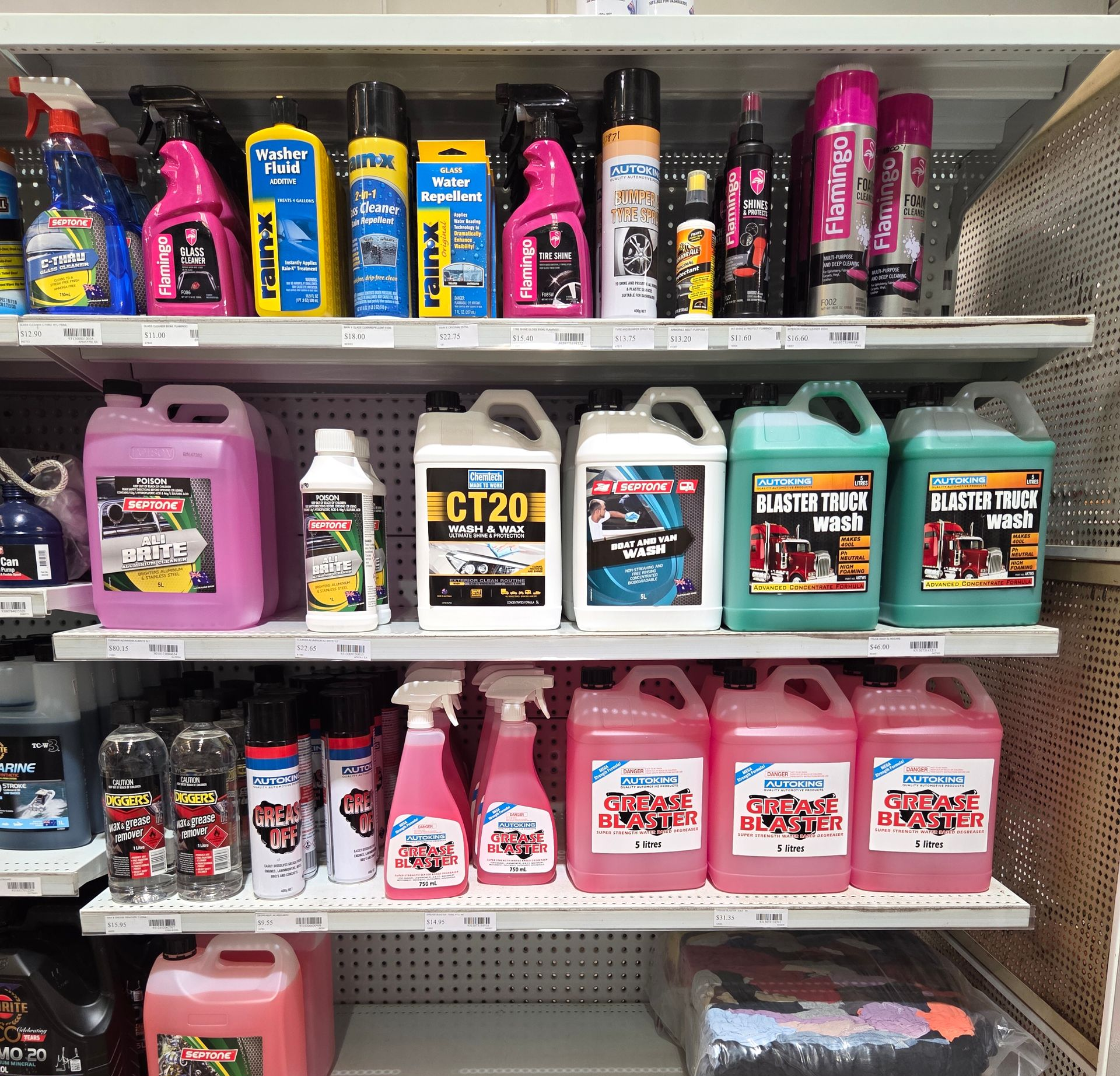 Store shelf stocked with colourful car-cleaning and detailing products in spray bottles and jugs. — Humpty Doo Hardware in Humpty Doo, NT