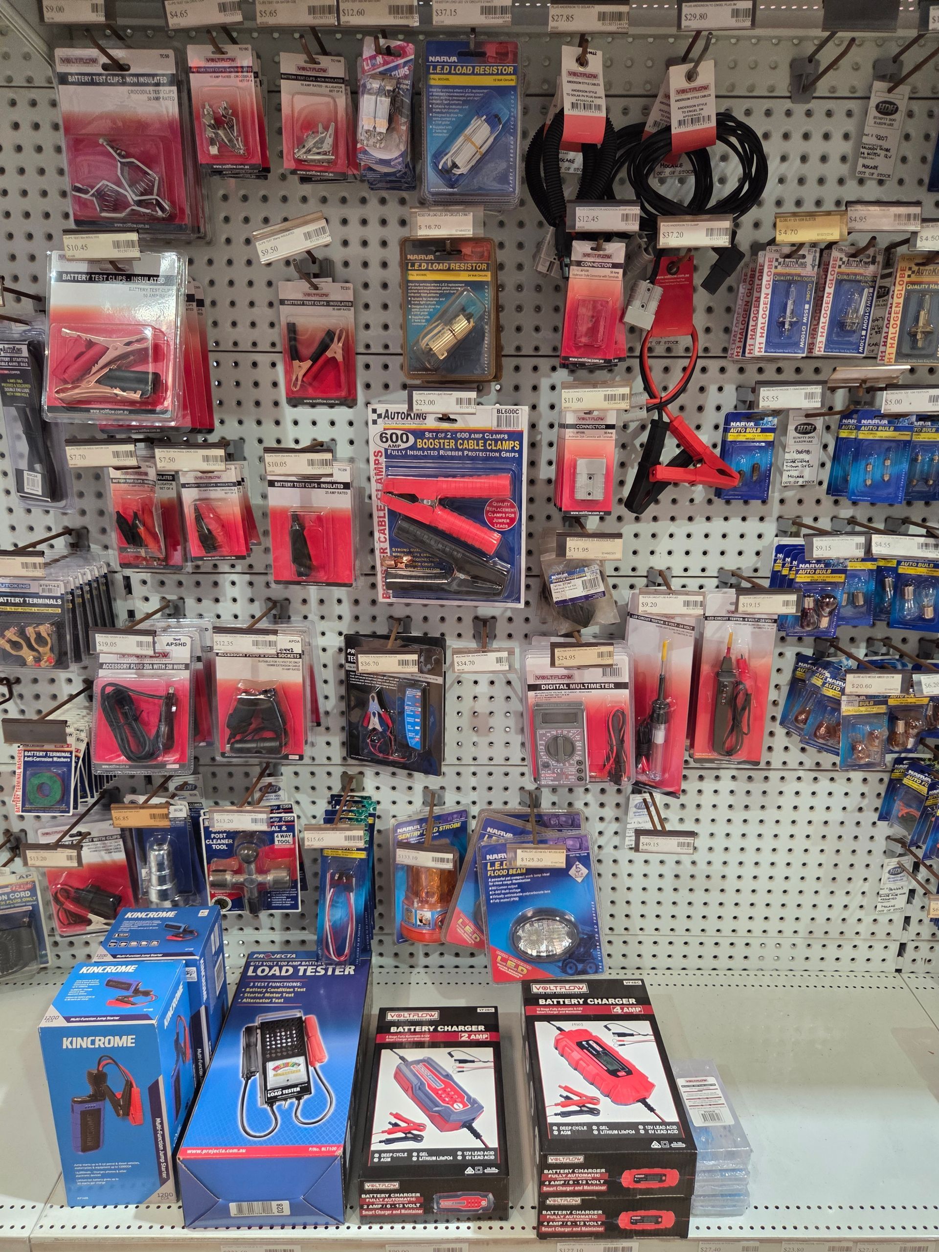 Pegboard display of assorted hand tools and accessories in red, black, and blue packaging in a hardware store — Humpty Doo Hardware in Humpty Doo, NT