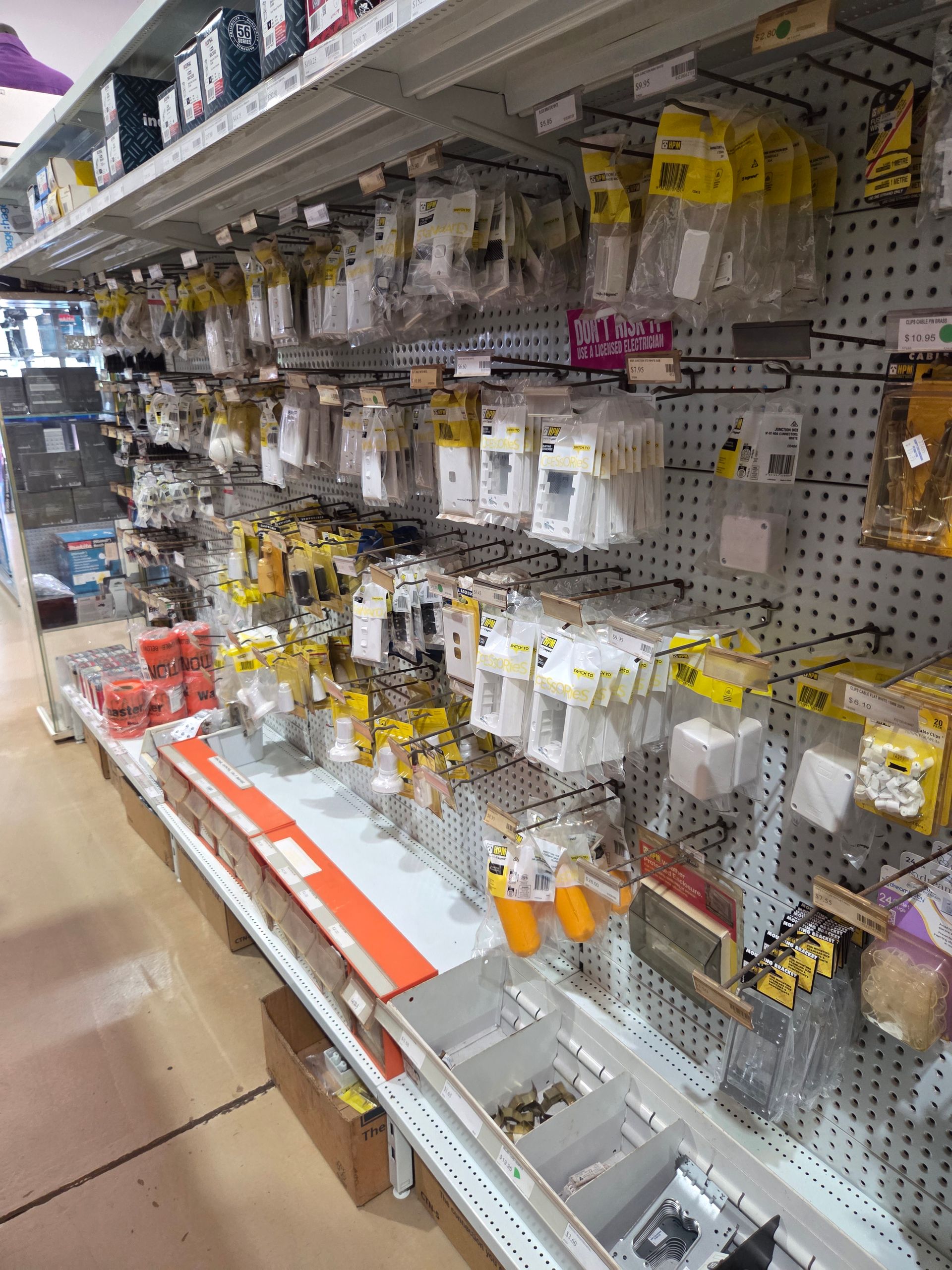 A Retail Store Aisle Featuring Rows of Packaged Electrical Components and Hardware — Humpty Doo Hardware in Humpty Doo, NT