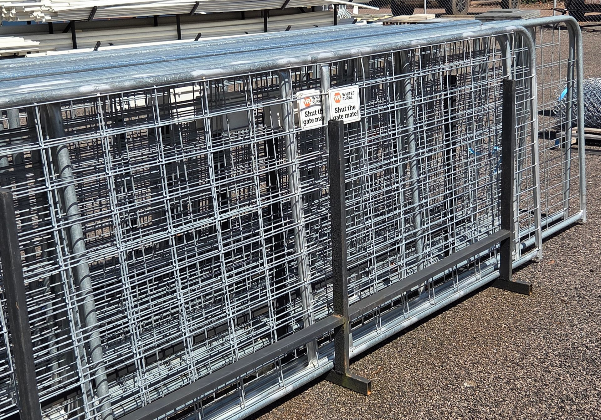 Stacked metal wire cages on pallets in an industrial storage area outdoors. — Humpty Doo Hardware in Humpty Doo, NT