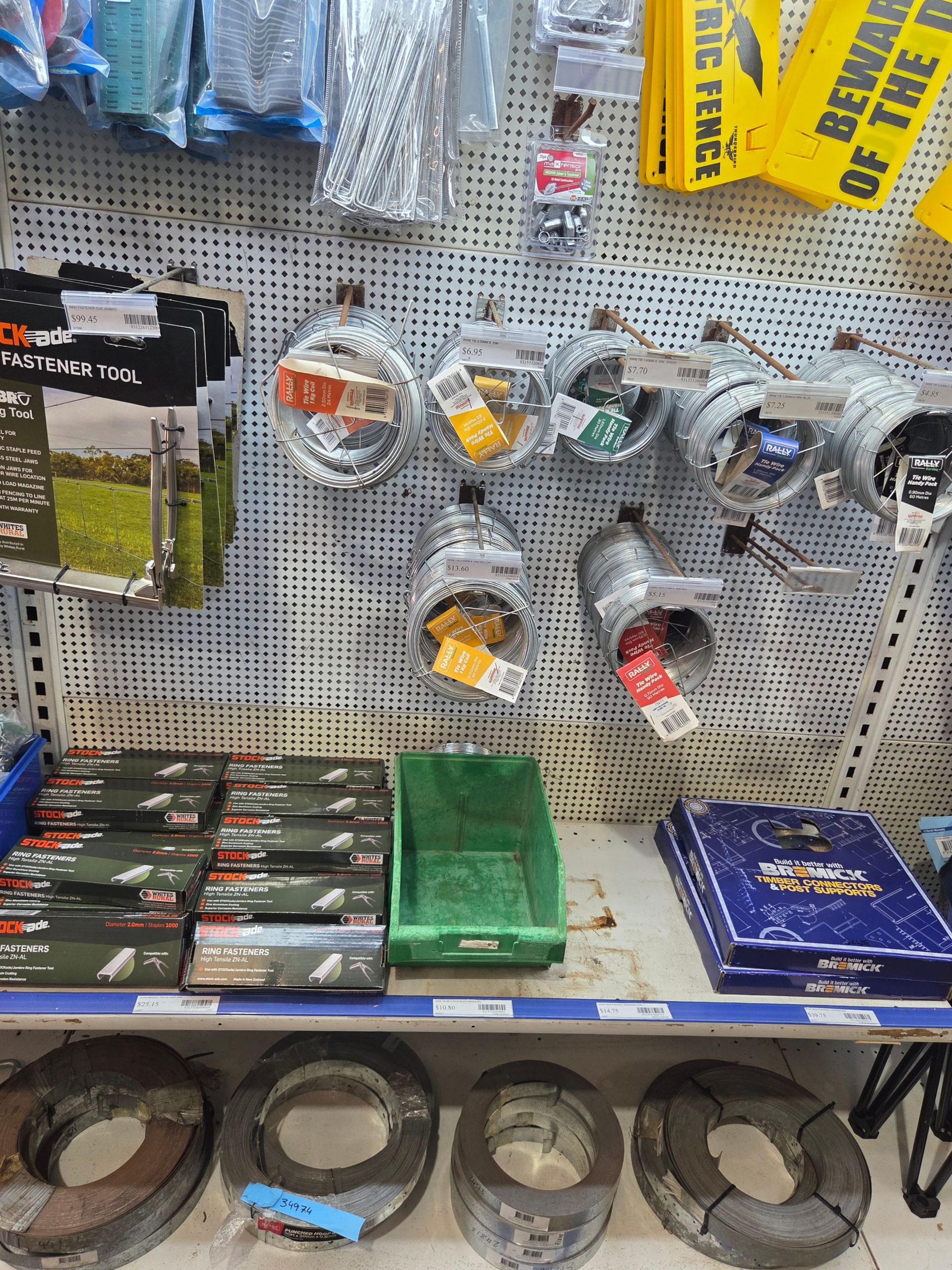 Hardware store aisle with pegboard display of tools and supplies, plus bins and coiled cables on shelves. — Humpty Doo Hardware in Humpty Doo, NT