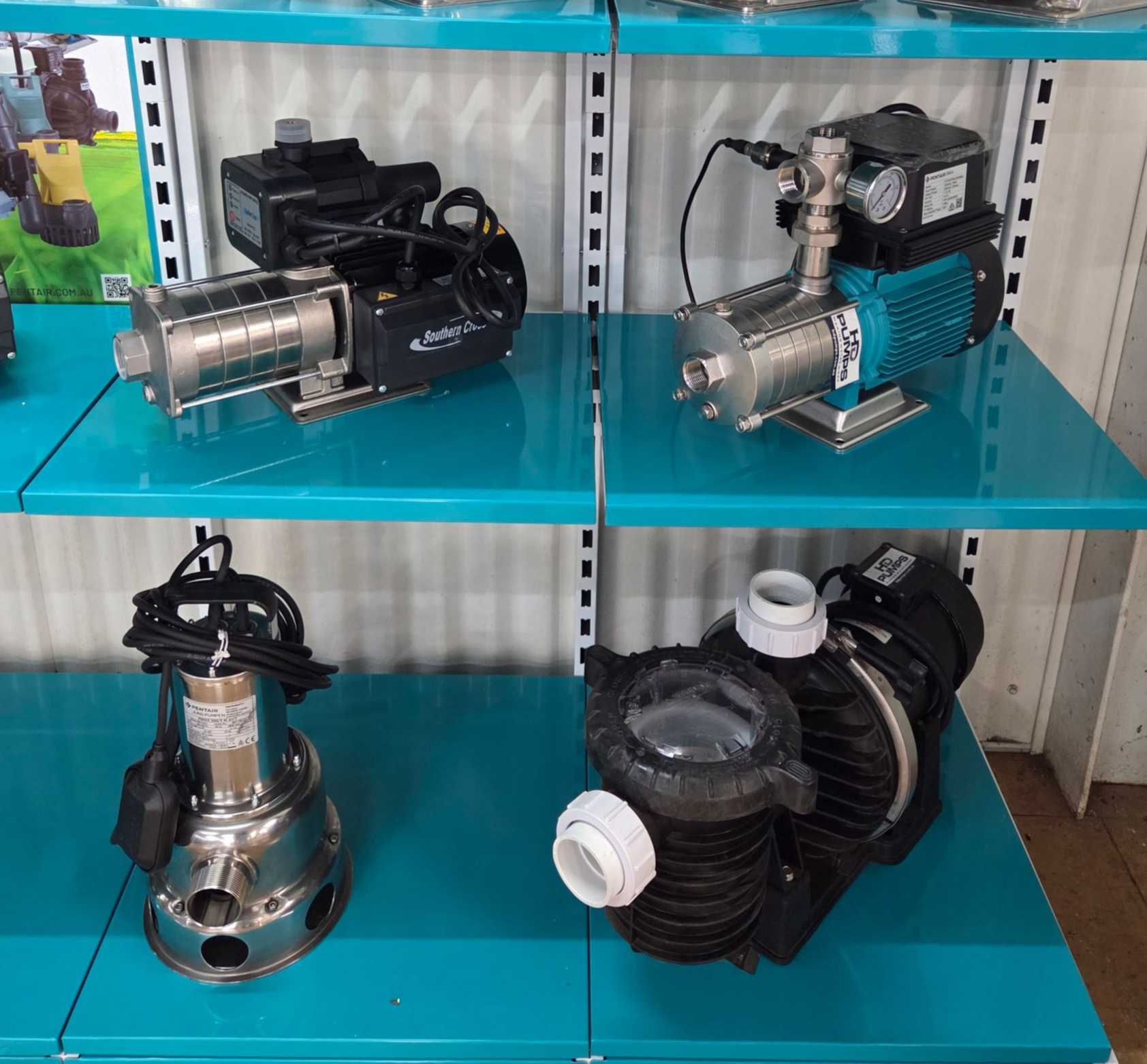 Shelved display of several industrial pump units with blue digital controls in a store or showroom — Humpty Doo Hardware in Humpty Doo, NT