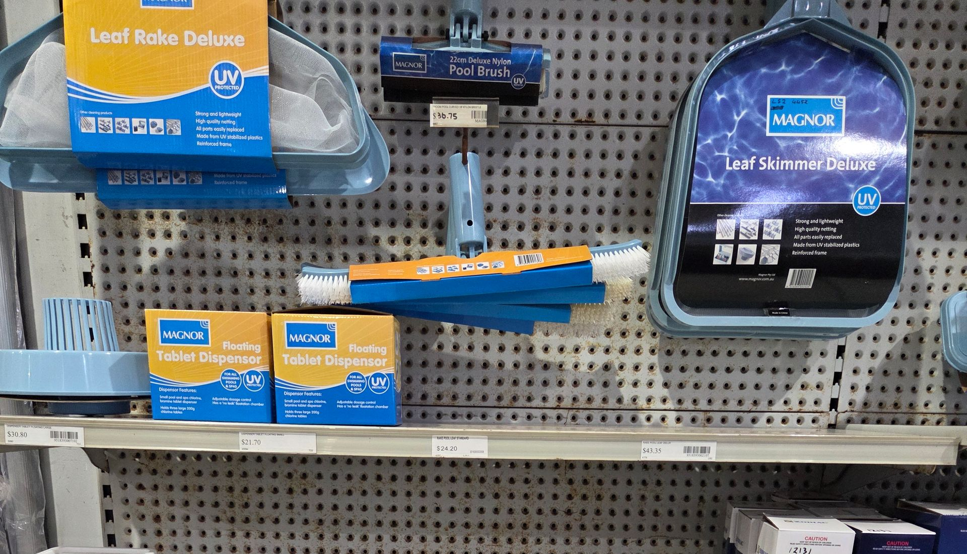 Store shelf with blue battery packs and accessories on a pegboard display — Humpty Doo Hardware in Humpty Doo, NT