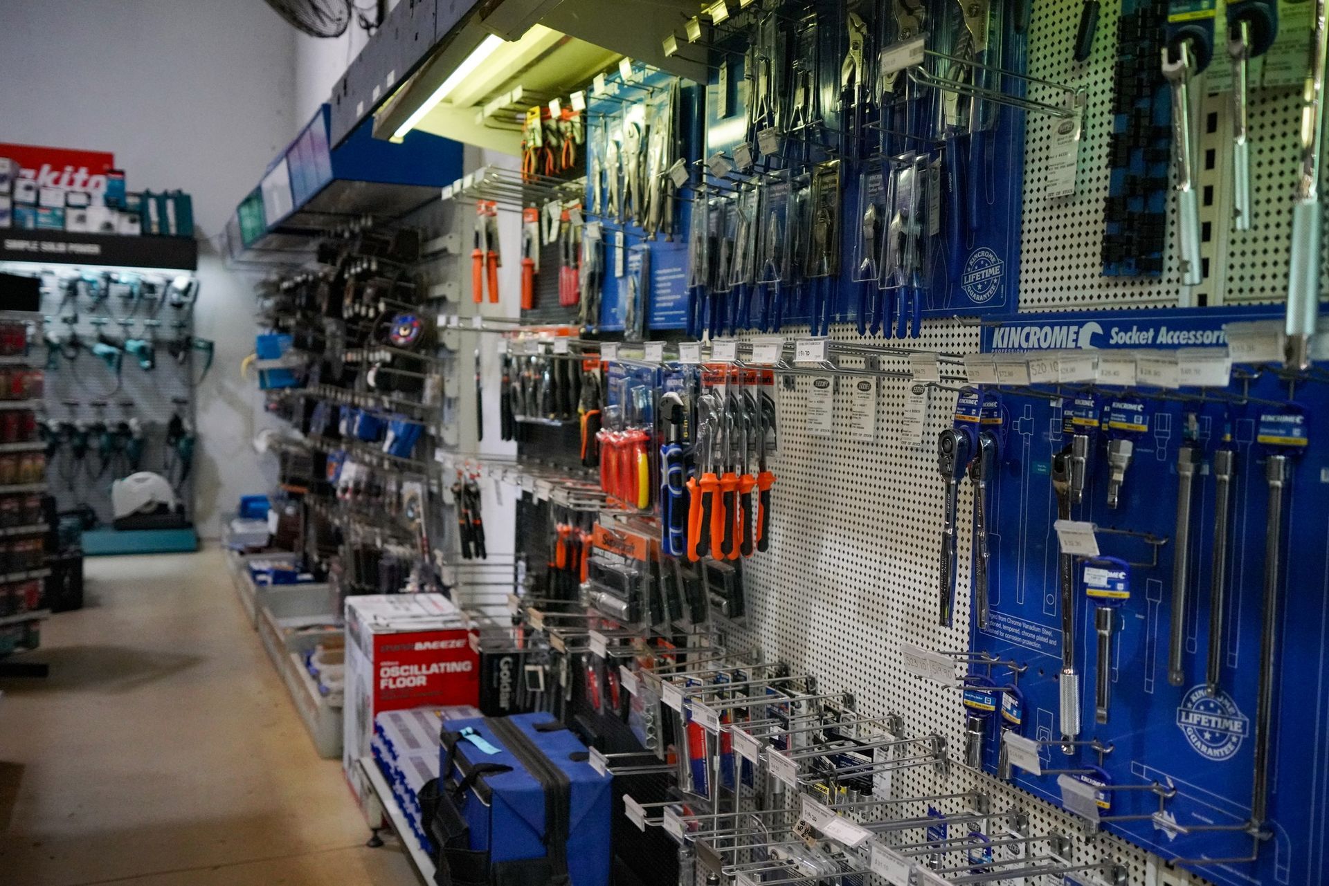 Hardware store aisle with hanging tools and supplies on blue and white pegboard displays — Humpty Doo Hardware in Humpty Doo, NT