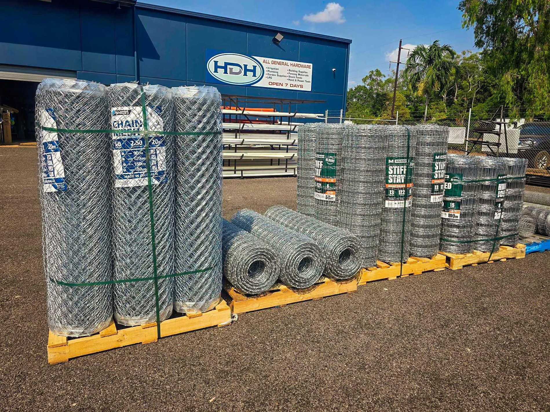 Several Rolls of Chain-link Fencing Stacked on Yellow Wooden Pallets — Humpty Doo Hardware in Humpty Doo, NT