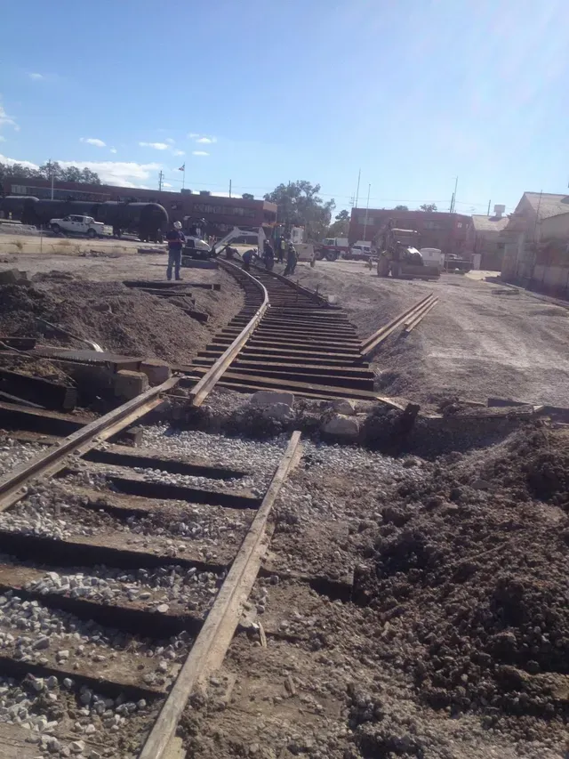 A train track is being built in a dirt field