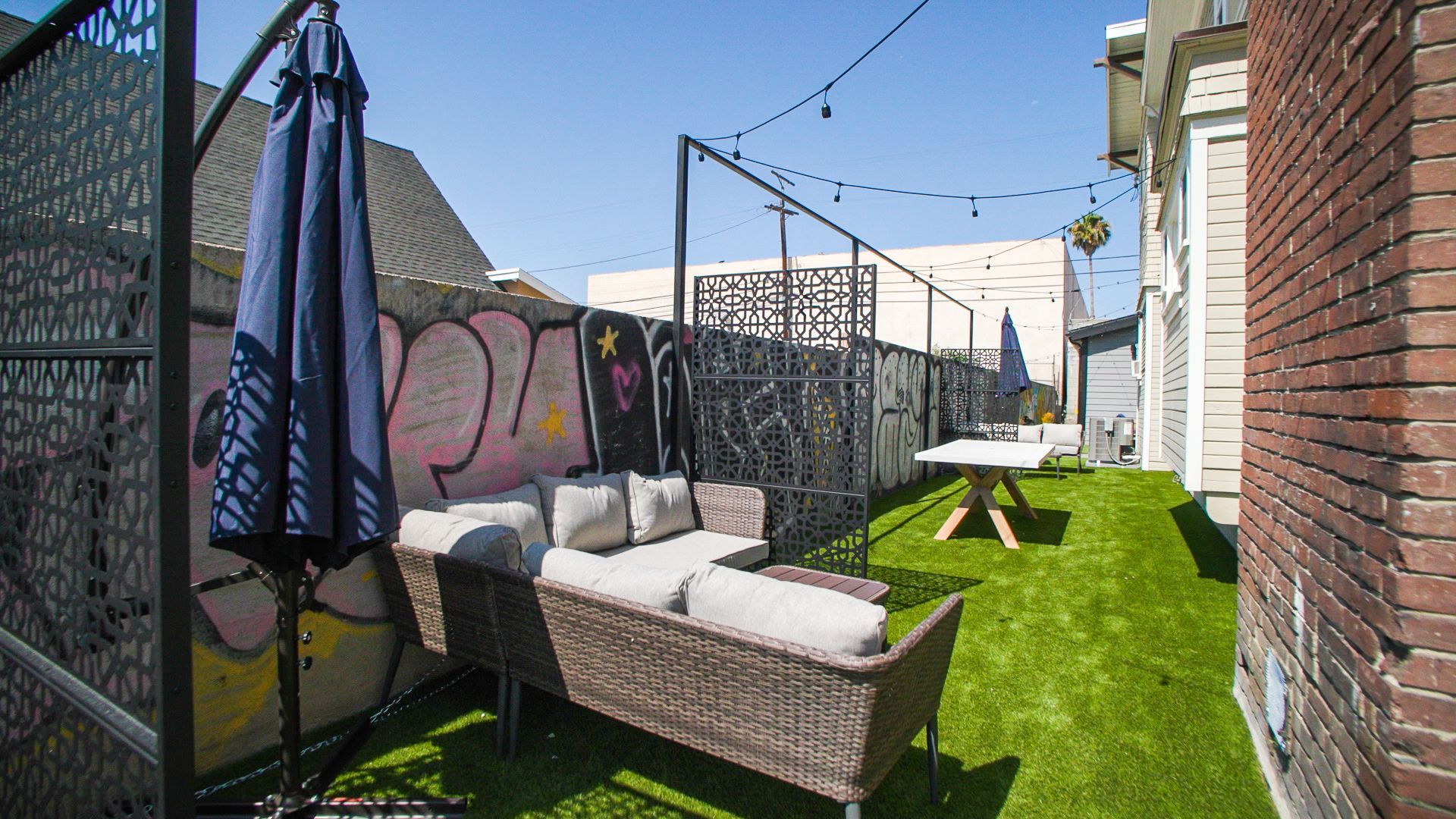 This image showing a garden with chairs and tables in it.