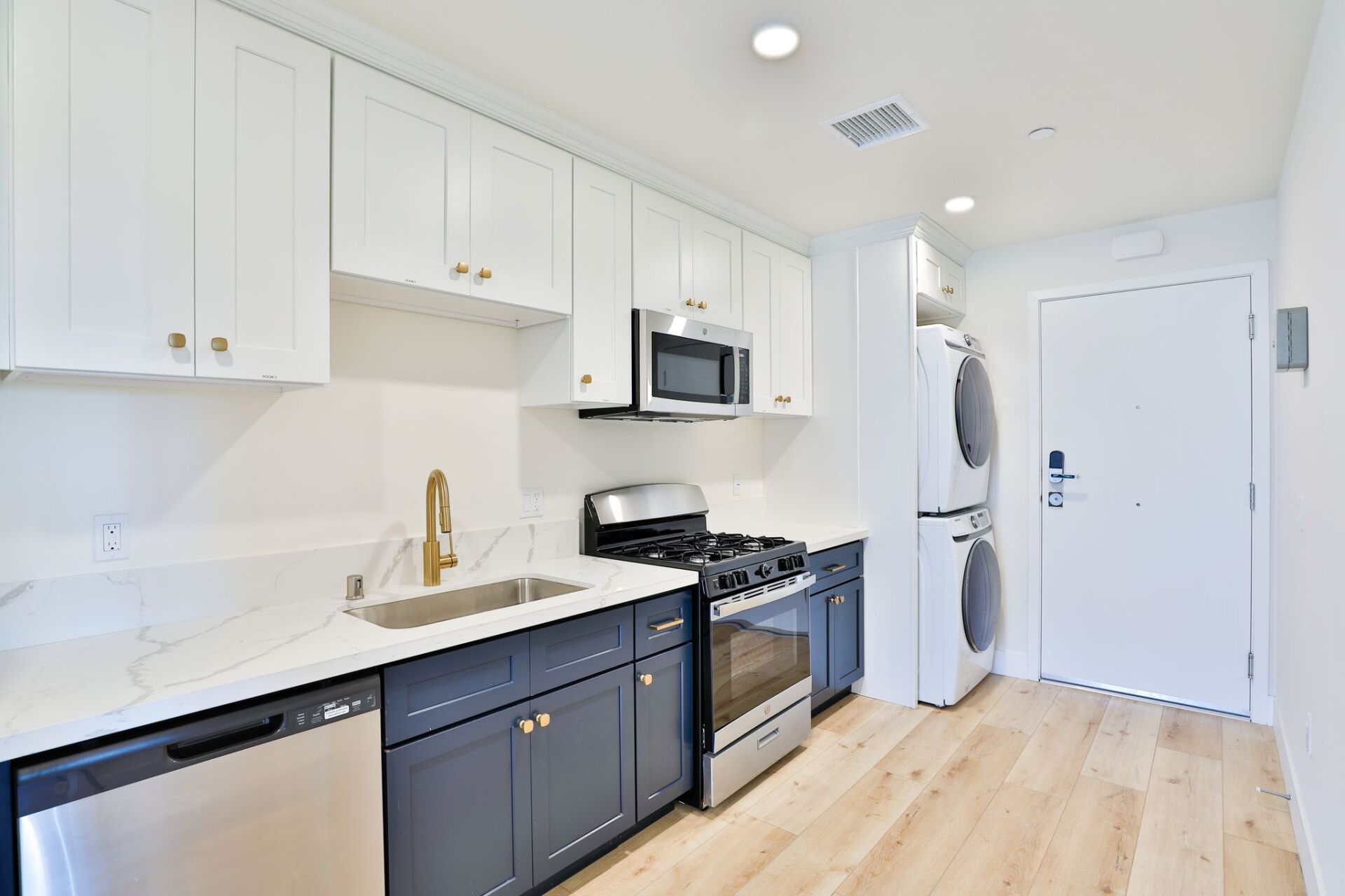 This image shows a kitchen with white cabinets and blue cabinets.