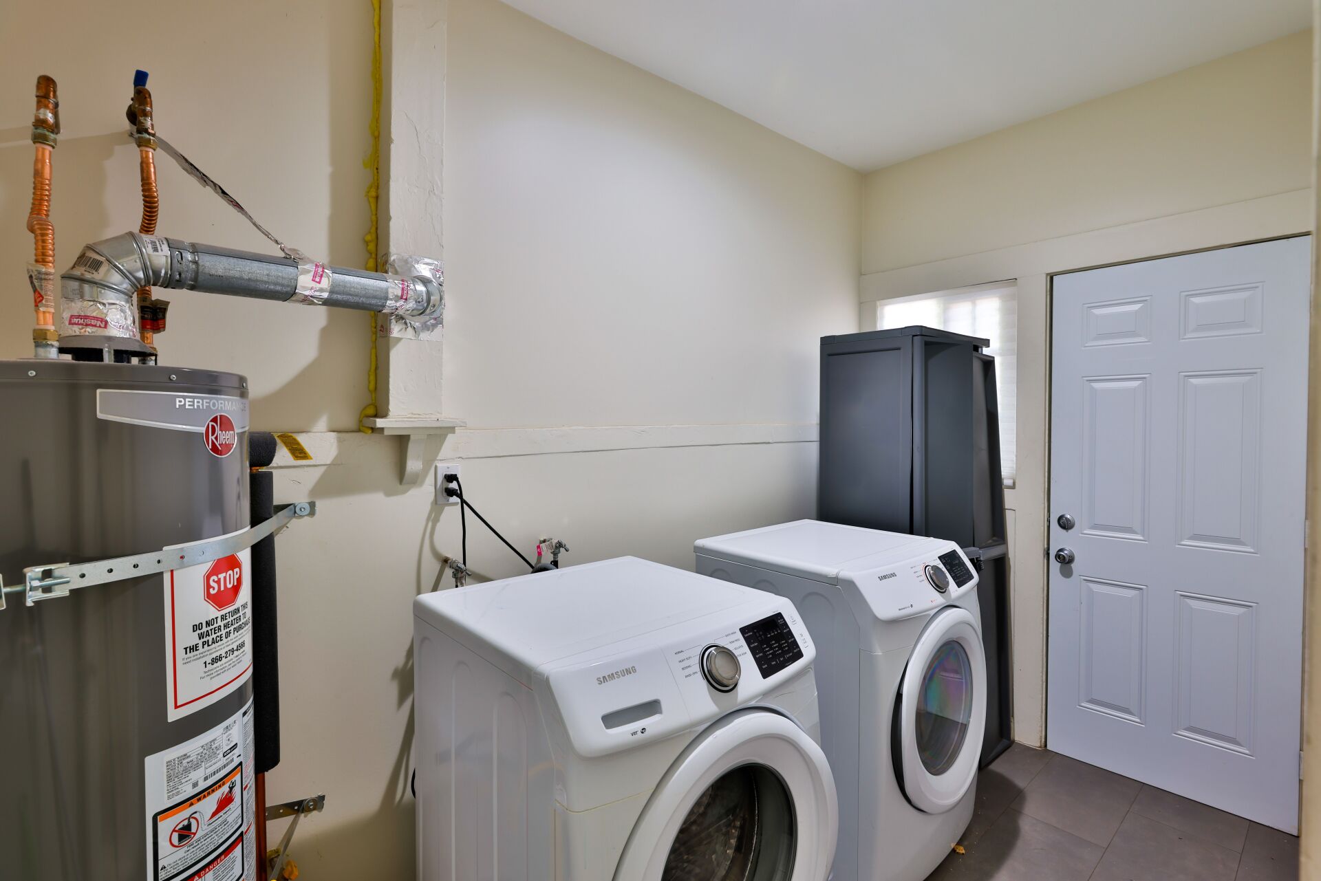 This image shows a laundry room with a dryer machine.