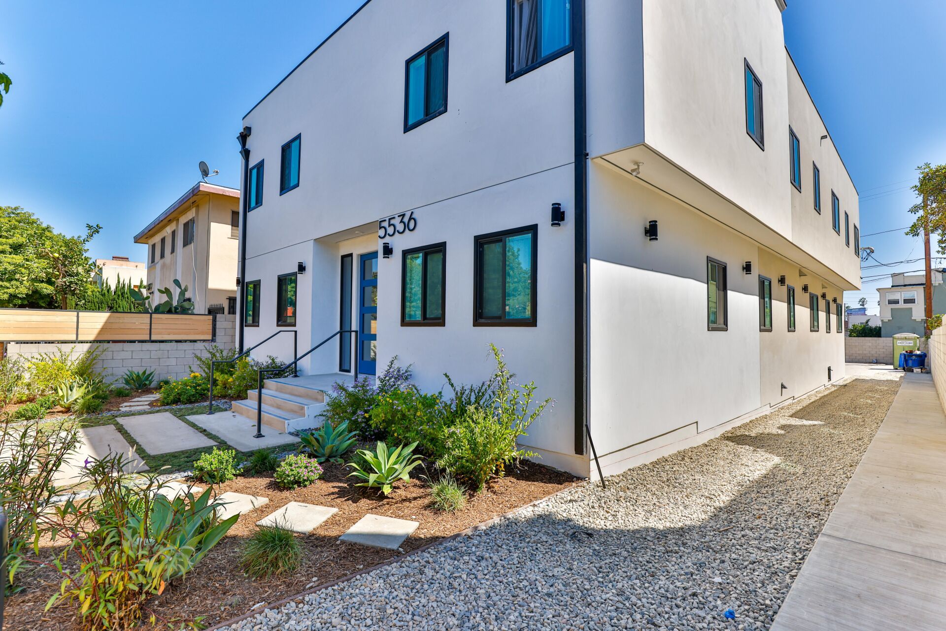 this image shows a luxury building with blue, green and white background.