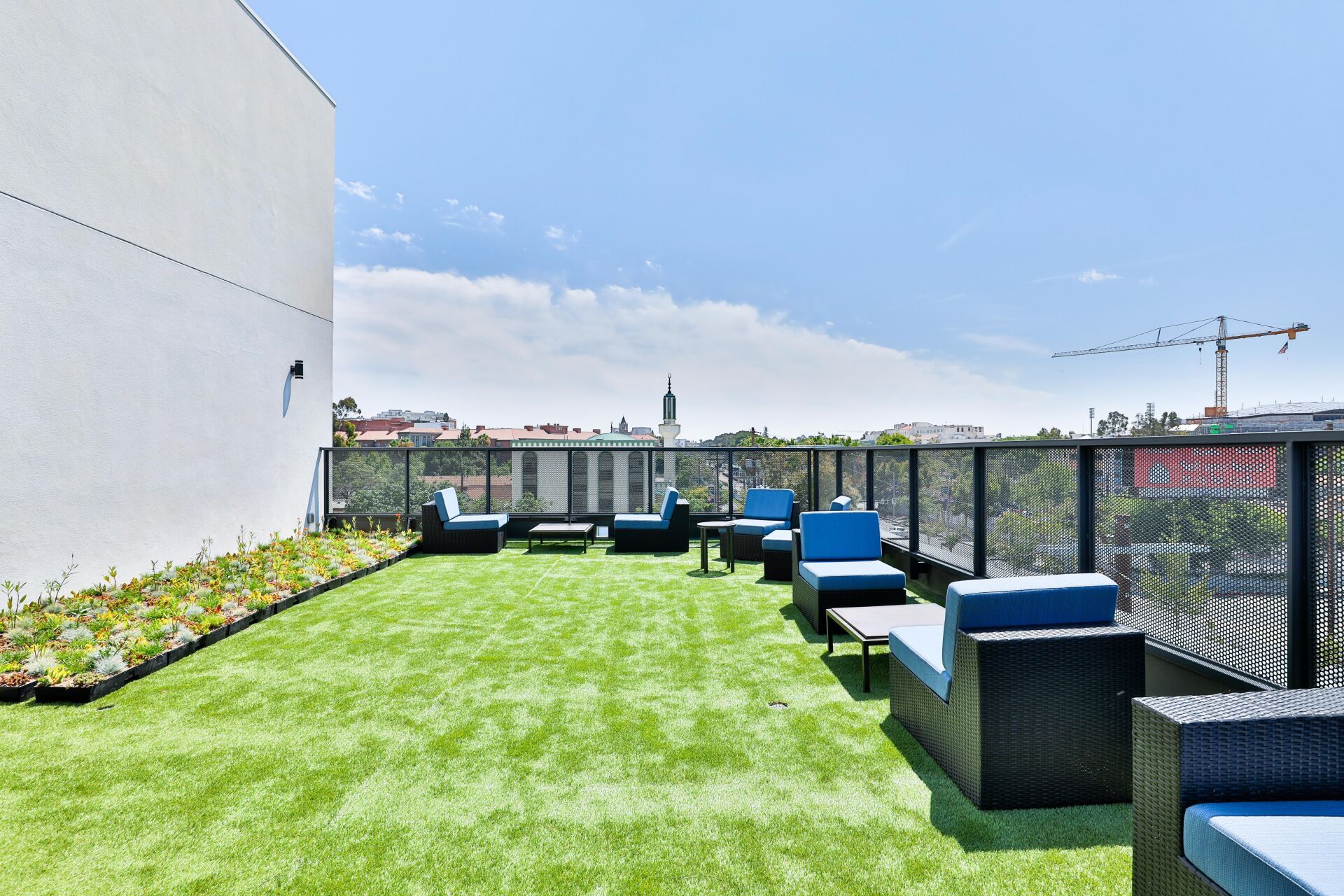 This image shows the sitting area on the roof of the a luxury building. 