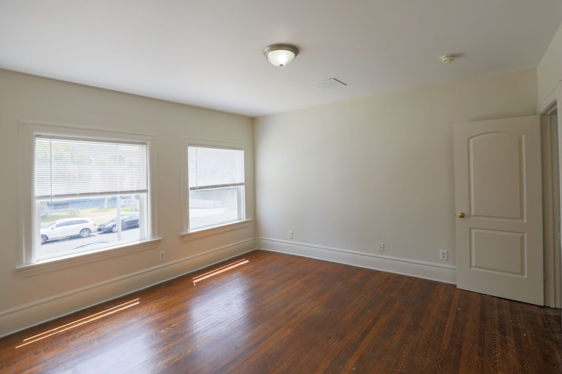 This image shows an empty room with 1 LED light and door