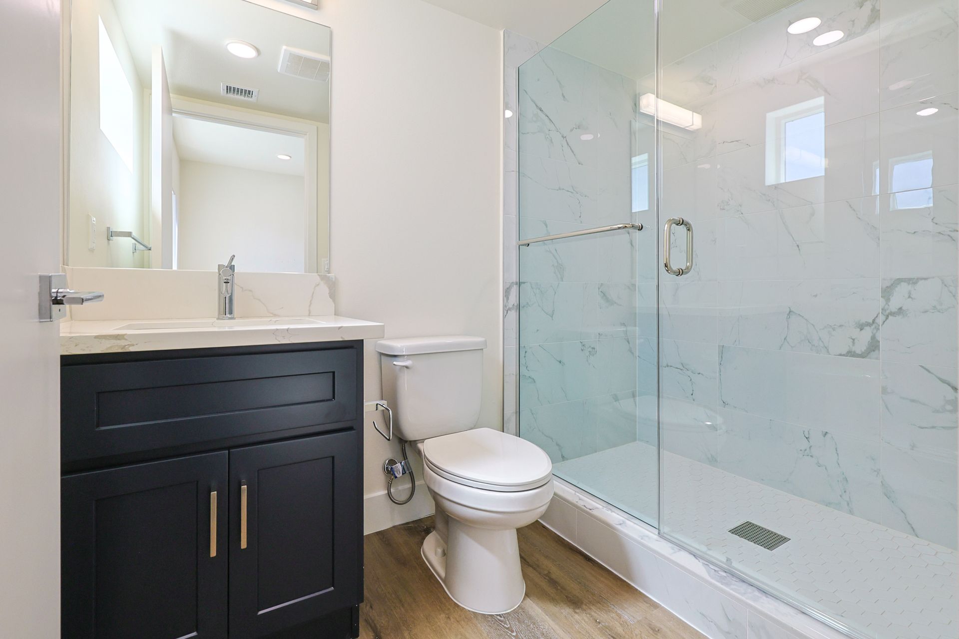 This image shows a bathroom with clear Glasses.