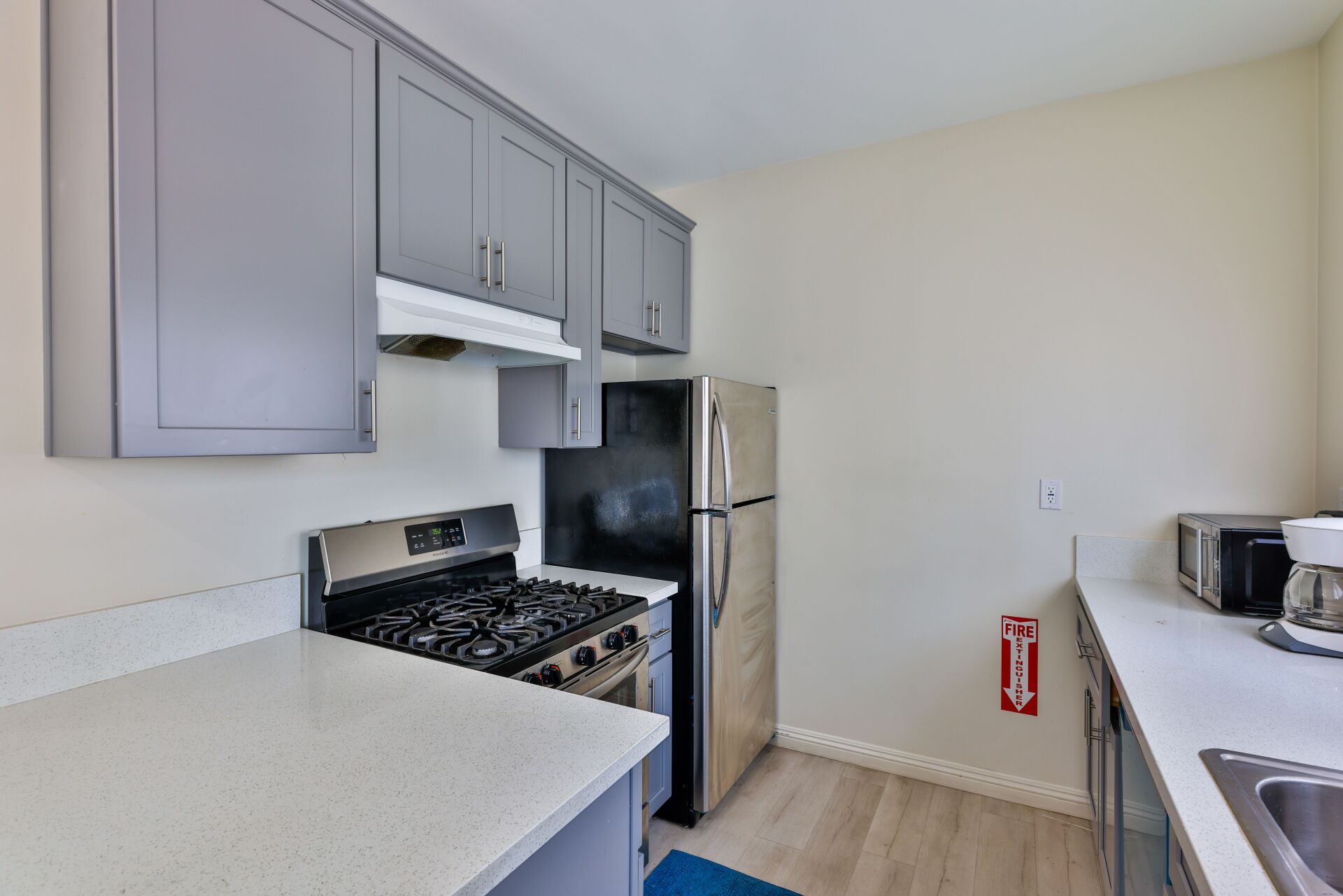 tihs image shows a small kitchen area with white background