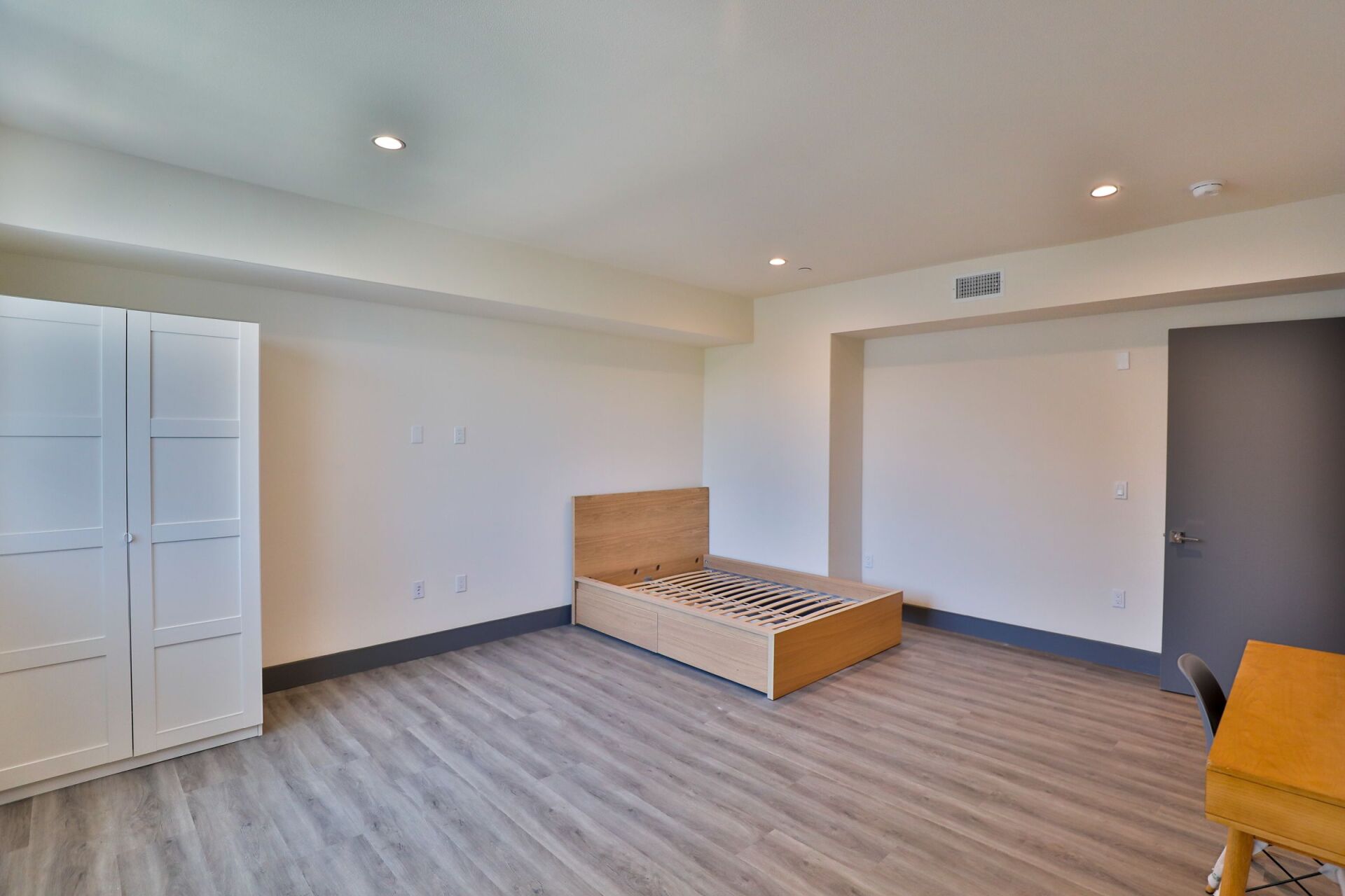 this image shows a wooden bed in the room