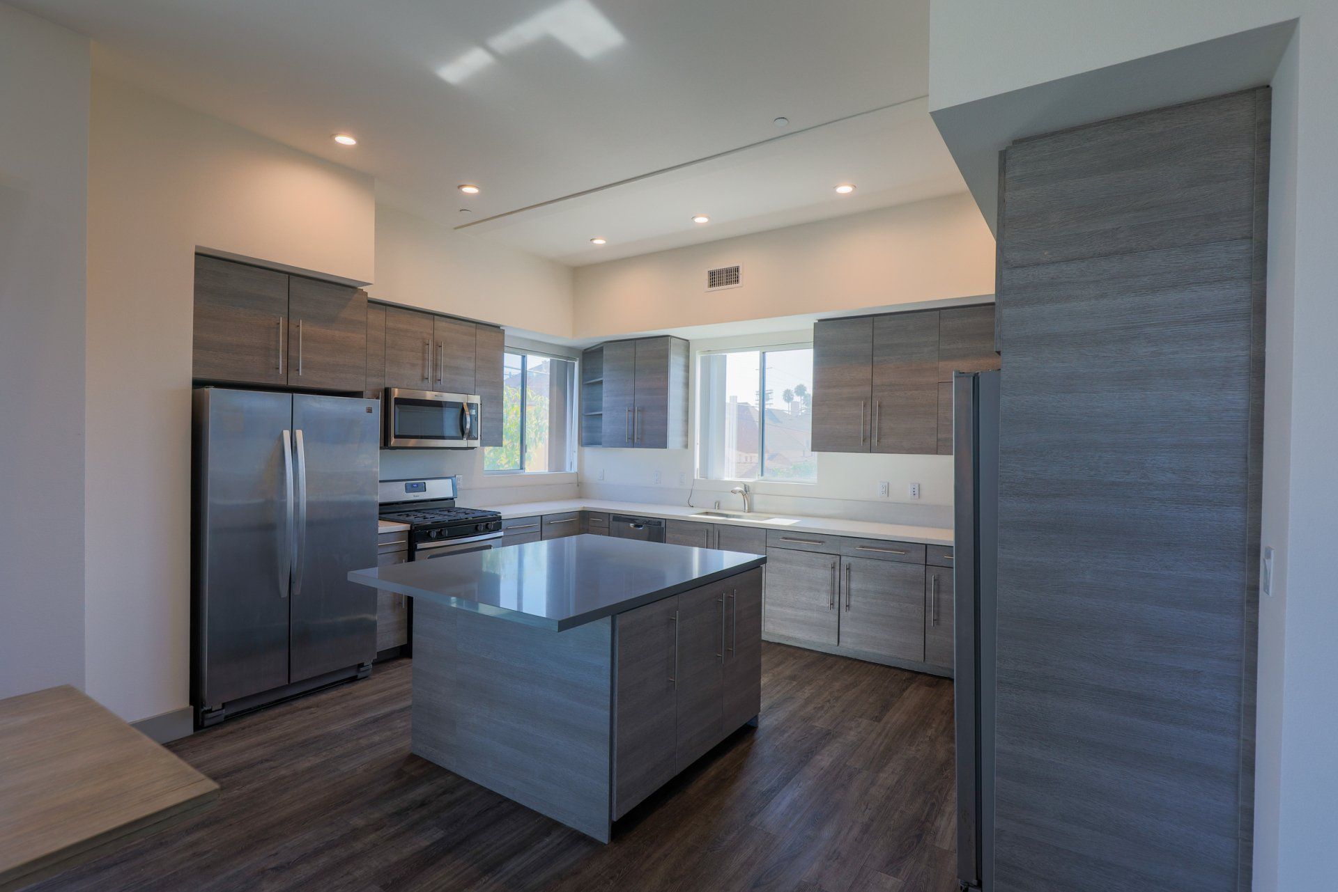This image shows a gray-colored theme kitchen with stainless steel appliances.