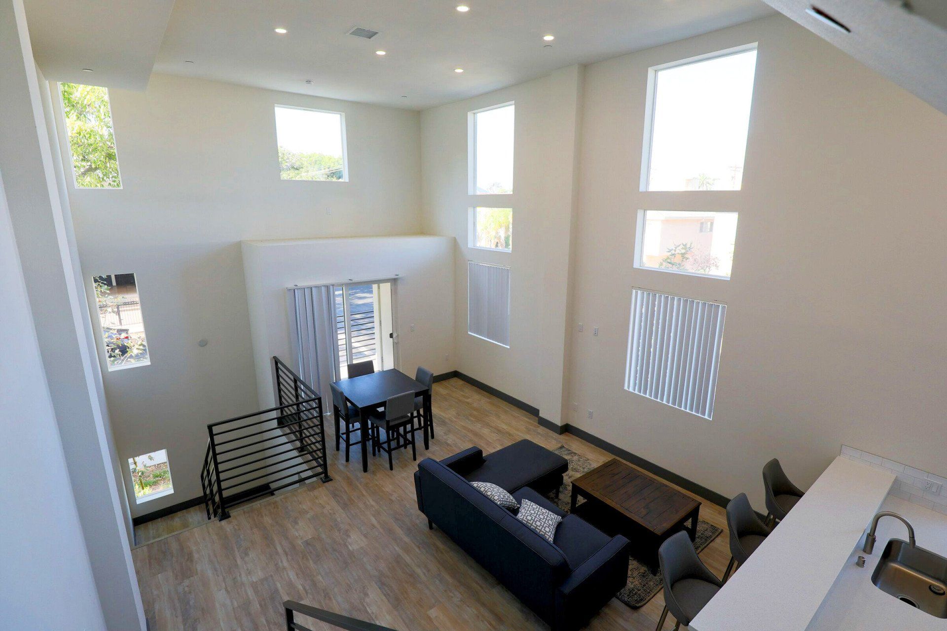 This image showing a spacious hall with lots of windows and furniture in it.