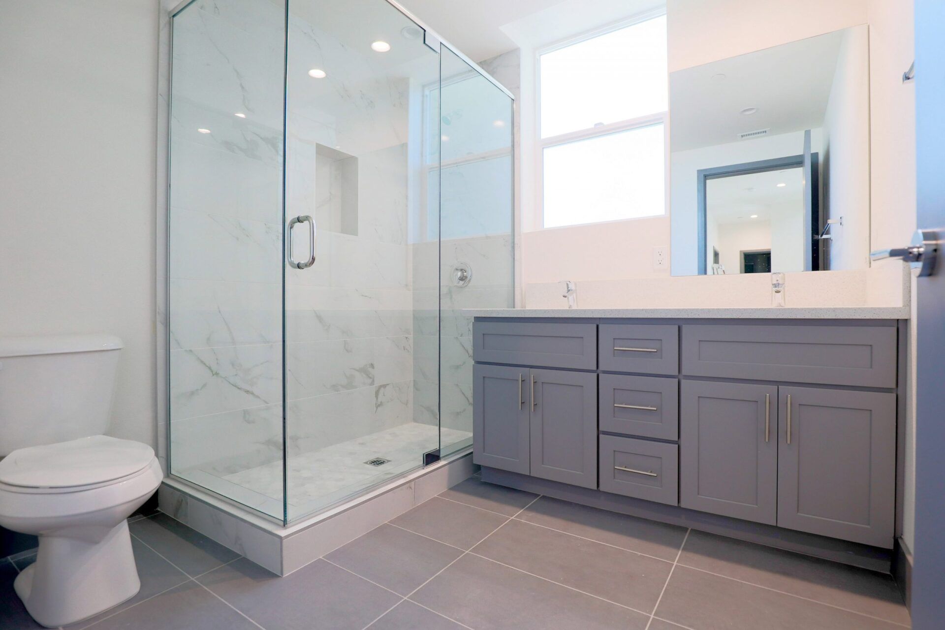 this image shows a small bathroom with grey background