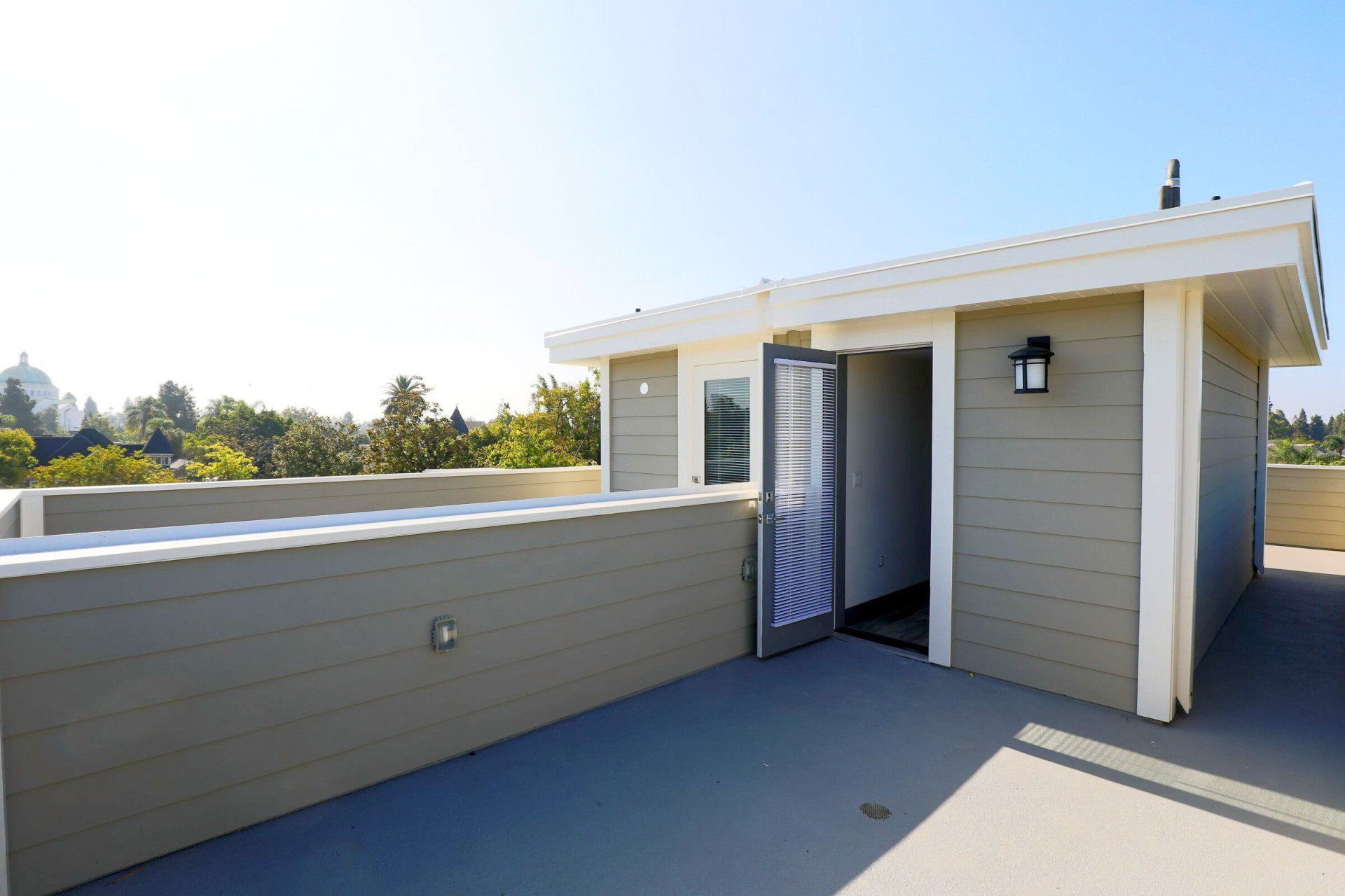 This image showing a spacious roof with beautiful entering beautiful door in it.