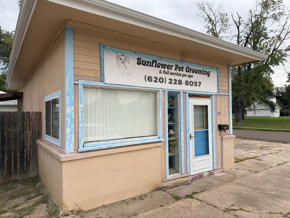 Sunflower Pet Grooming storefront with beige siding, blue trim, and large front windows