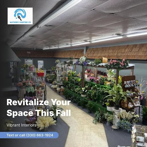 Indoor garden center with fall décor, plants, and flowers; text reads “Revitalize Your Space This Fall.”