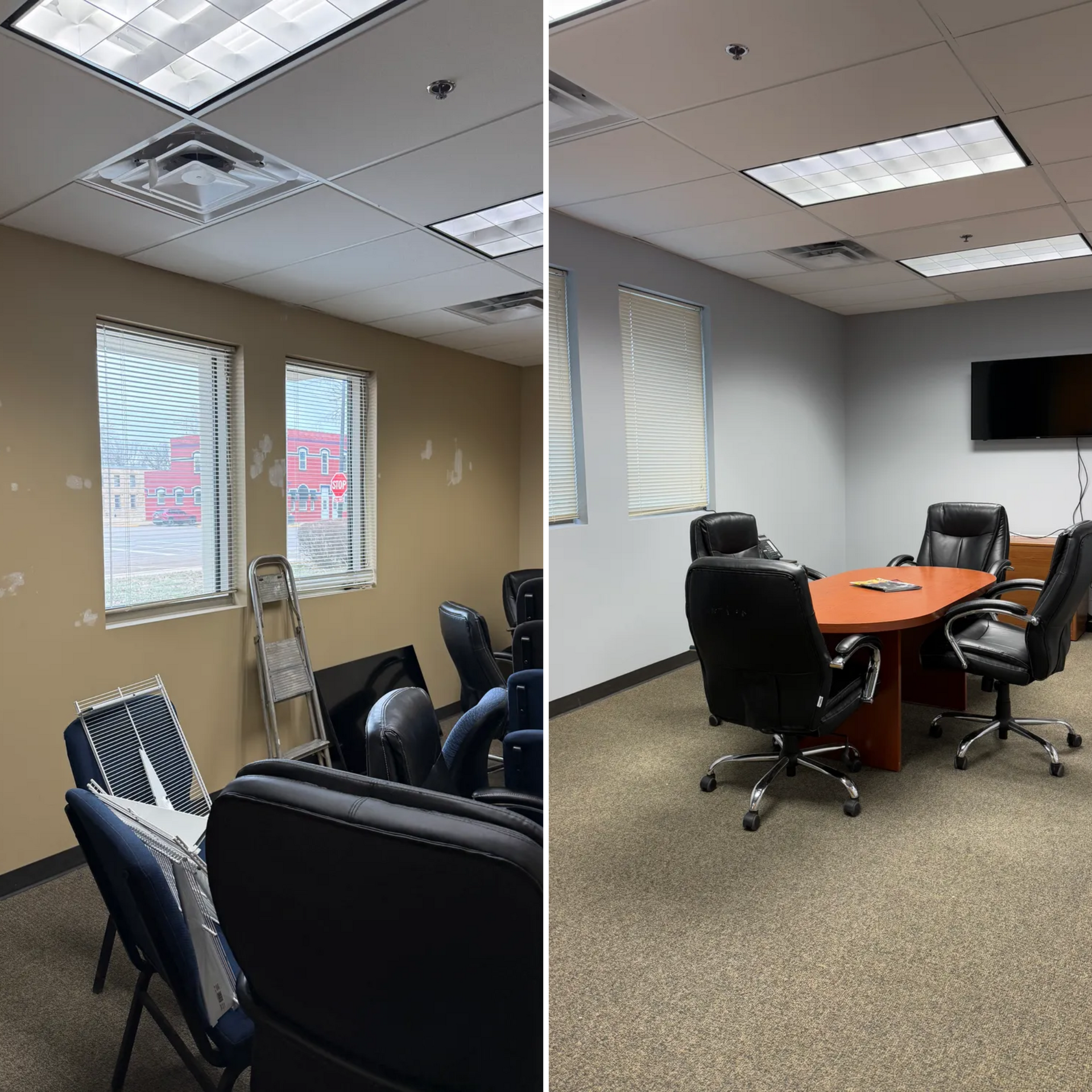 Empty office conference room with chairs, round table, wall-mounted TV, and overhead fluorescent lights