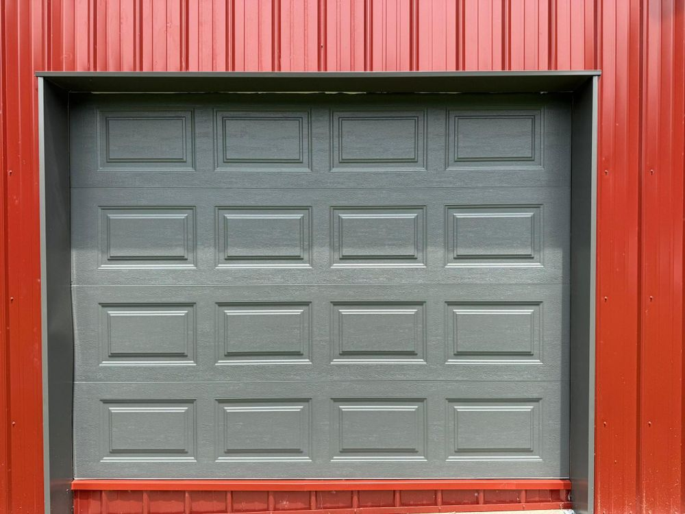 Gray garage door in a red corrugated metal wall