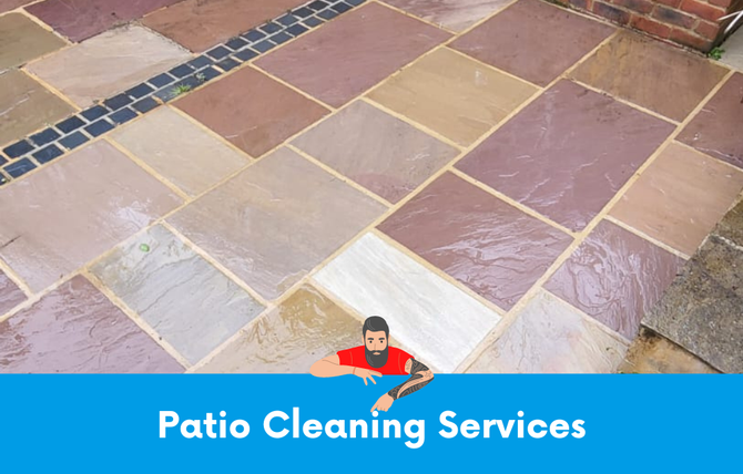 A man with a beard is sitting on a tiled patio.