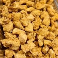 Close-up of golden-brown fried chicken pieces piled together