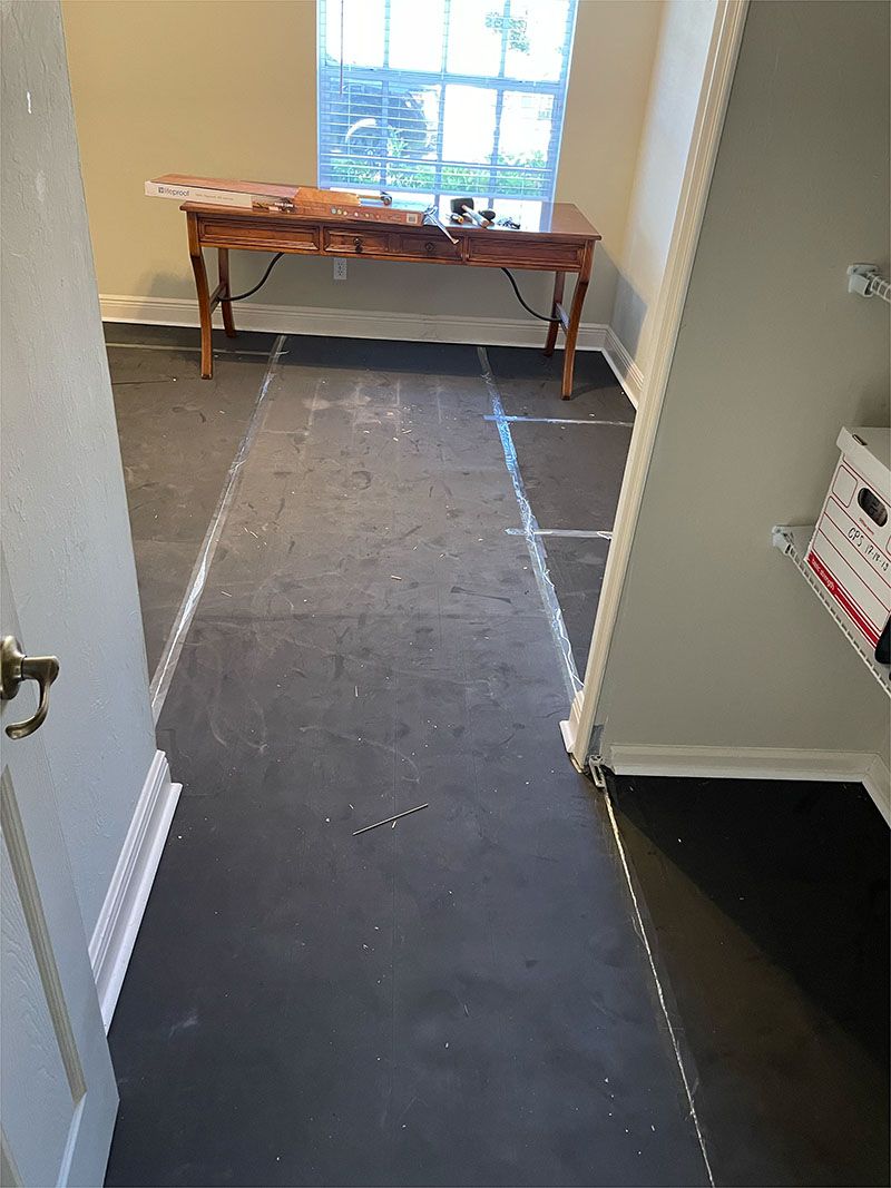 A room with a table and a window is being remodeled.