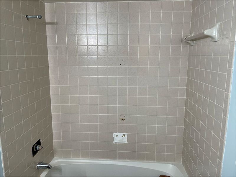 A bathroom with a bathtub and a shower.