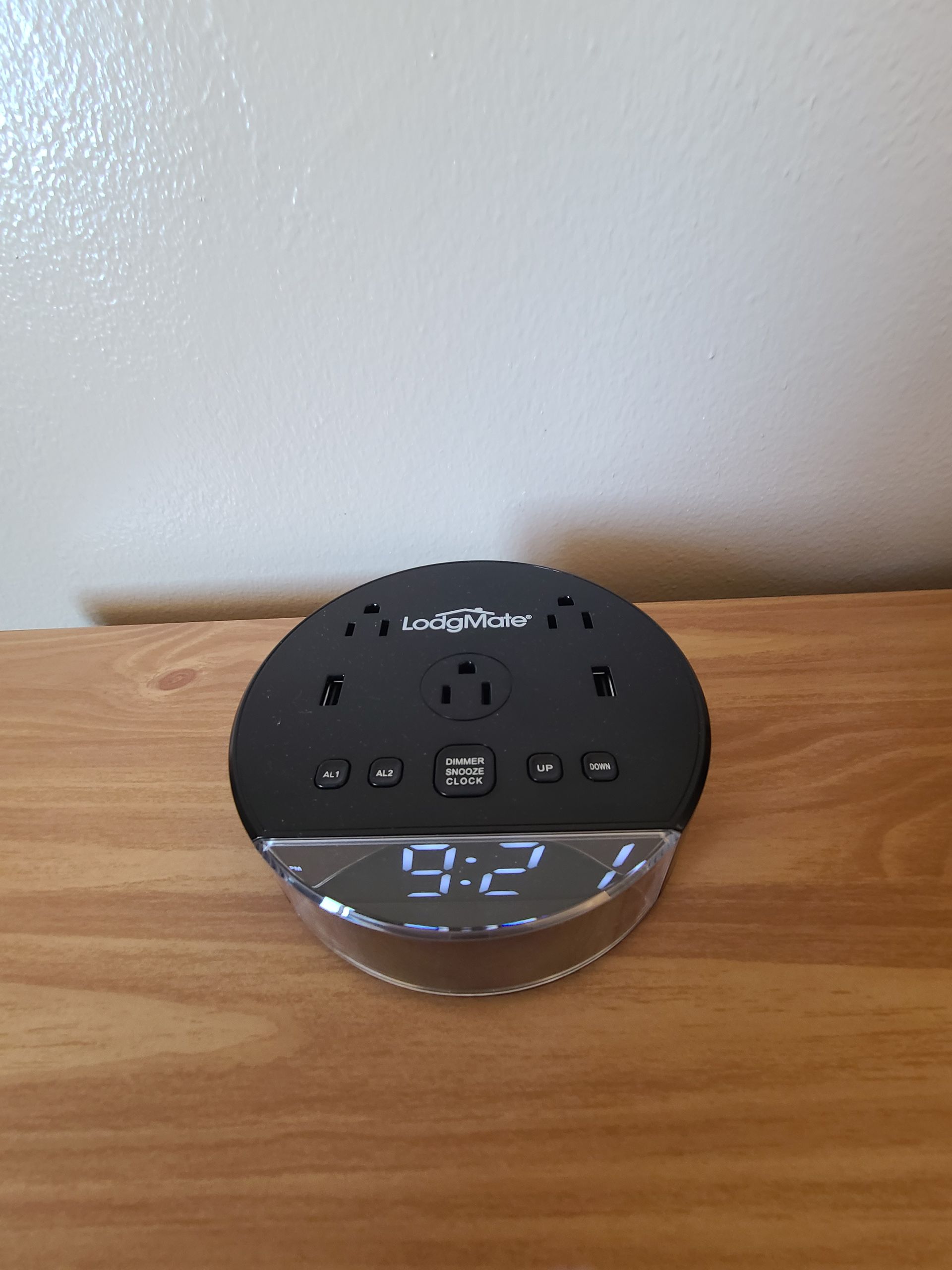 Black clock radio with outlets and USB port, displaying the time 9:2.